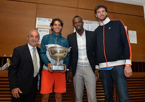 Rafael Nadal, Usain Bolt, and Pau Gasol pose with the 2013 French Open trophy