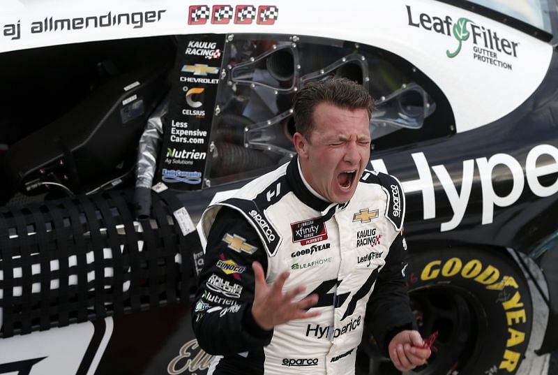 AJ Allmendinger celebrates after winning the NASCAR Xfinity Series Drive for the Cure 250 presented by Blue Cross Blue Shield of North Carolina . (Photo by Brian Lawdermilk/Getty Images)