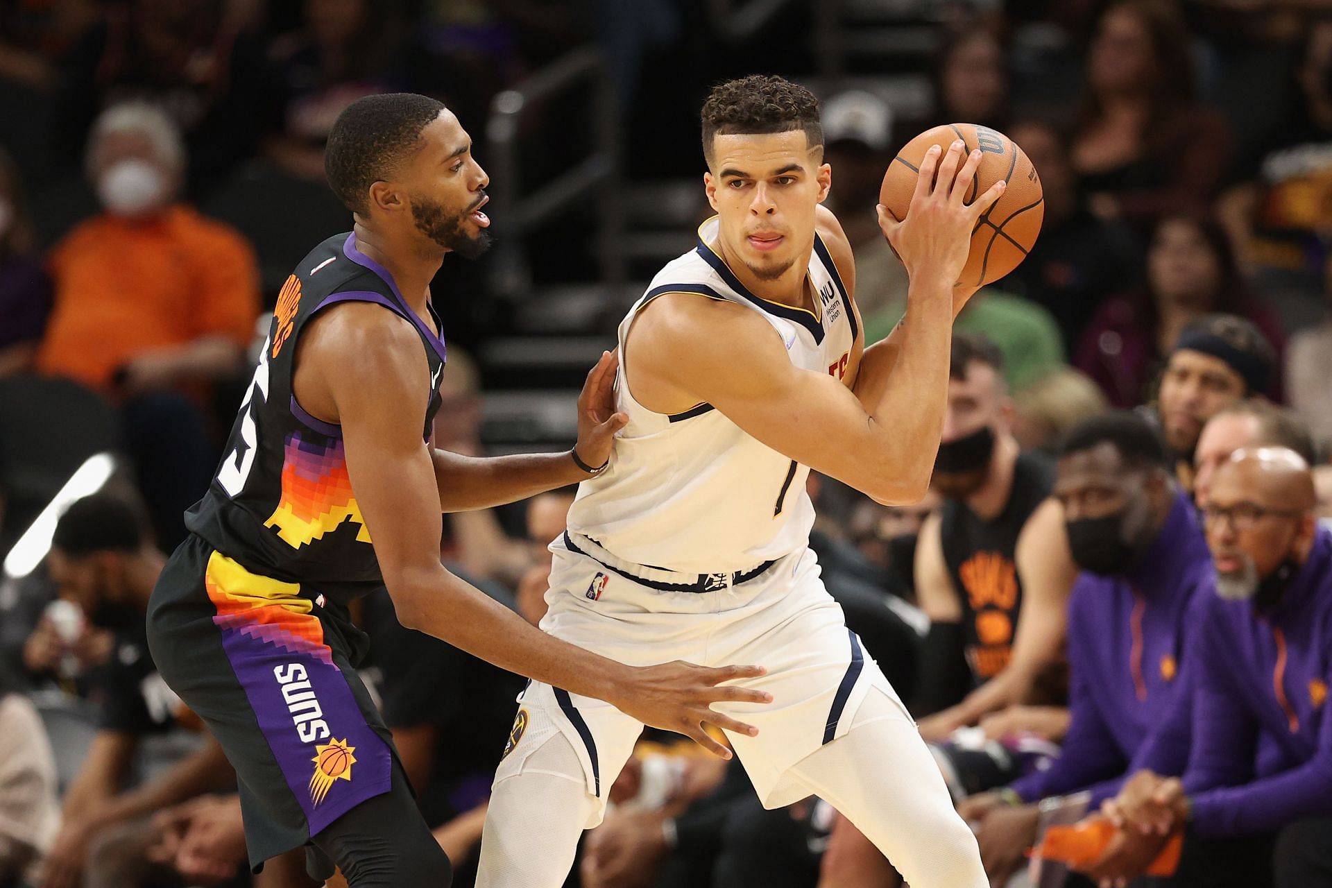 Michael Porter Jr. #1 of the Denver Nuggets handles the ball against Mikal Bridges #25 of the Phoenix Suns during the second half of the NBA game at Footprint Center on October 20, 2021 in Phoenix, Arizona.