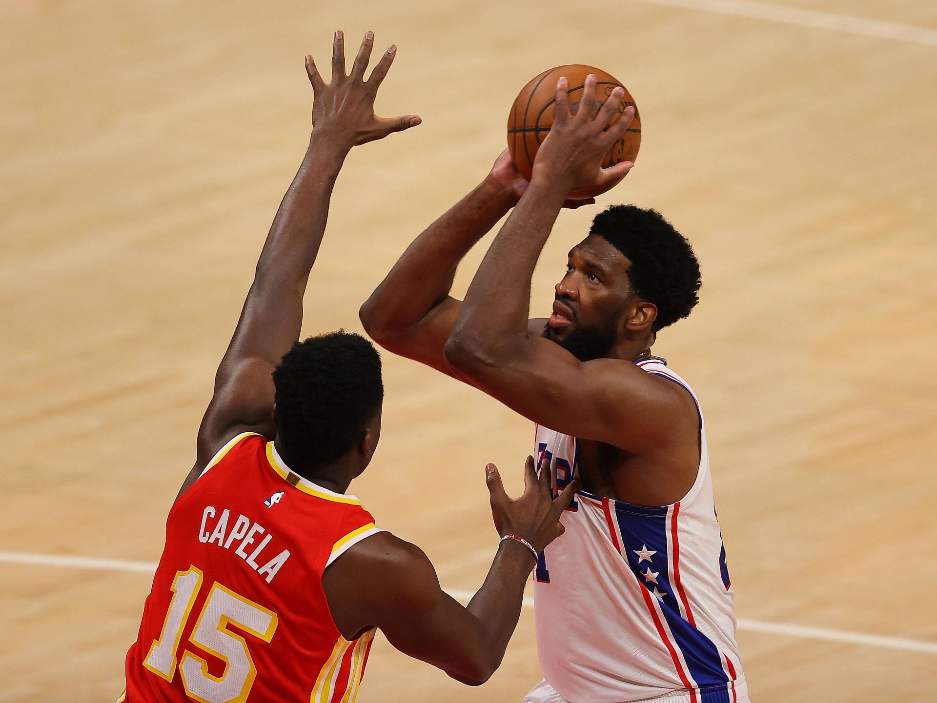 Joel Embiid #21 of the Philadelphia 76ers drives against Clint Capela #15 of the Atlanta Hawks during the first half of game 3 of the Eastern Conference Semifinals at State Farm Arena on June 11, 2021 in Atlanta, Georgia.