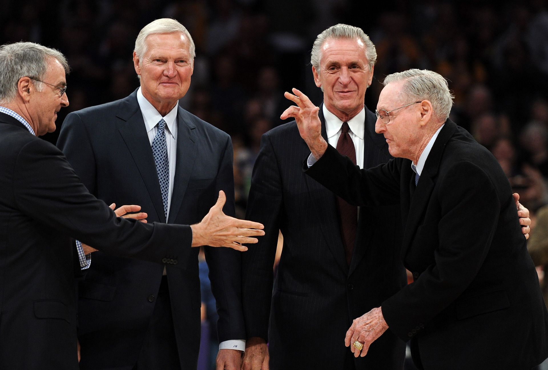 Bill Sharman receives a handshake from Gail Goodrich in front of Jerry West and Pat Riley as the 1972 NBA Championshipi team is honored at halftime during the game between the Houston Rockets and the Los Angeles Lakers at Staples Center on April 6, 2012 in Los Angeles, California.