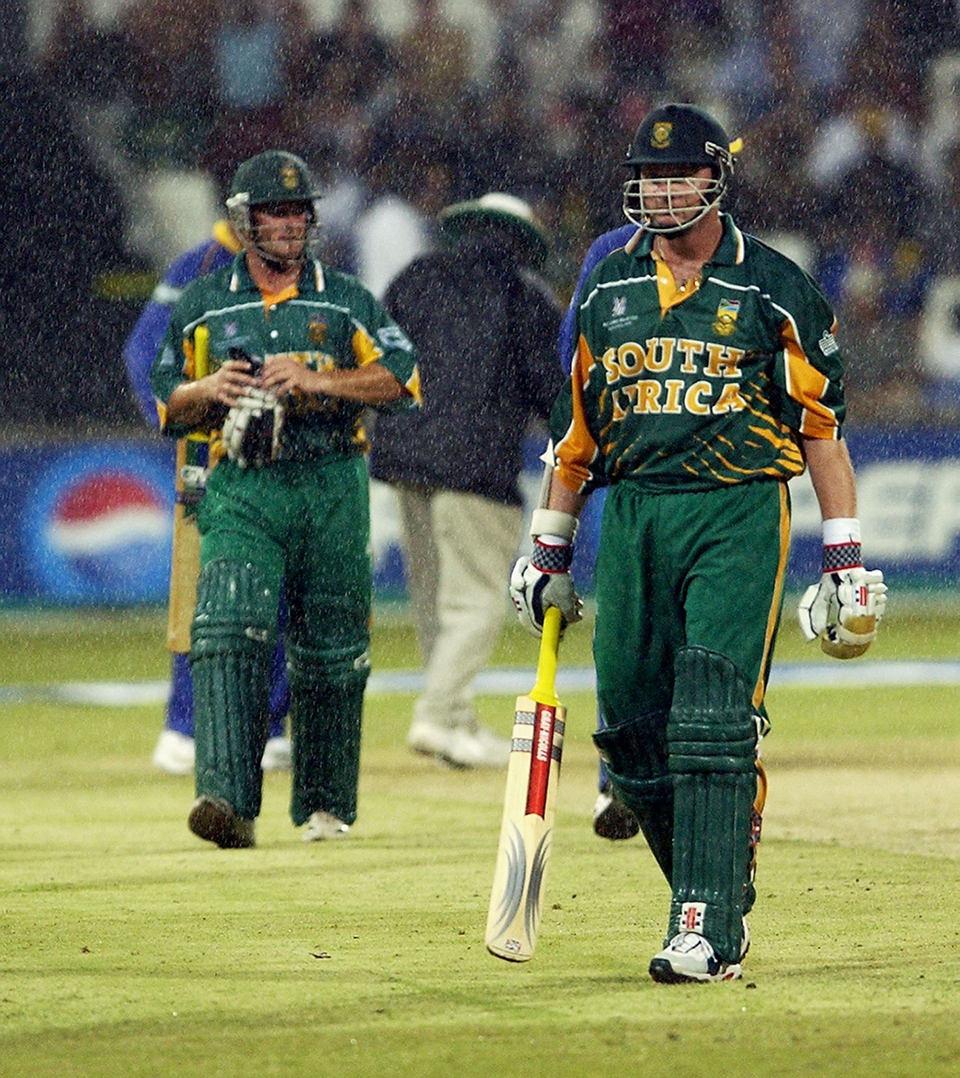 Lance Klusener and Mark Boucher leave the field as rain falls during the ICC Cricket World Cup 2003 match. Pic: Getty Images