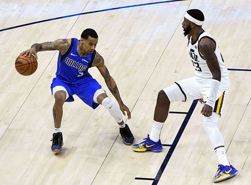 Trey Burke of the Dallas Mavericks guarded by Royce O'Neal