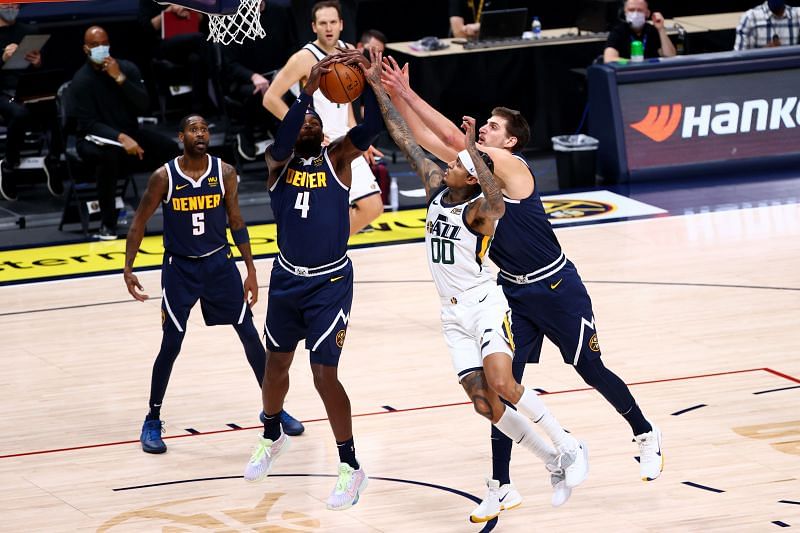 Nikola Jokic battling for a rebound with Utah&#039;s Jordan Clarkson