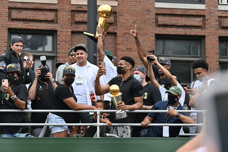 Giannis Antetokounmpo of the Milwaukee Bucks holds up his MVP trophy for the crowd during the Milwaukee Bucks 2021 NBA Championship Parade and Rally on July 22, 2021 in Milwaukee, Wisconsin.