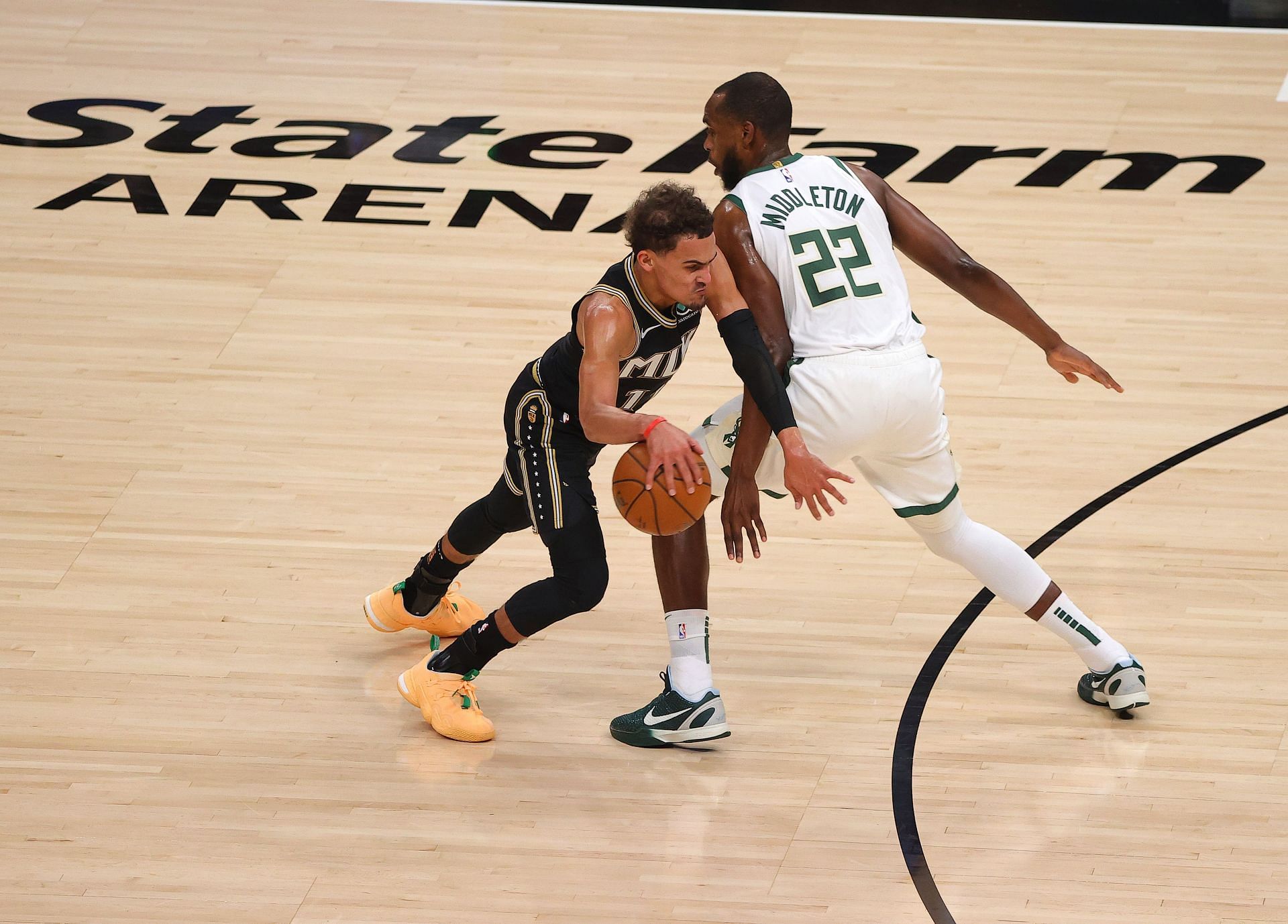 Trae Young #11 of the Atlanta Hawks drives to the basket against Khris Middleton #22 of the Milwaukee Bucks during the first half in Game Six of the Eastern Conference Finals at State Farm Arena on July 03, 2021 in Atlanta, Georgia.