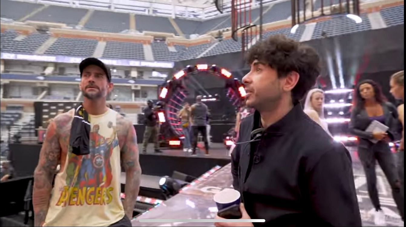 CM Punk and Tony Khan discussing backstage