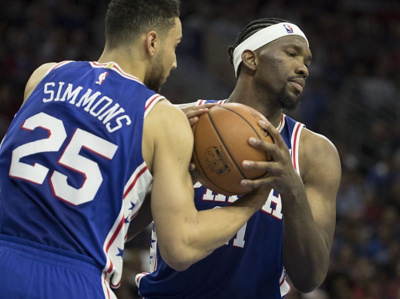 Ben Simmons and Joel Embiid secure the basketball in a game against the Boston Celtics.