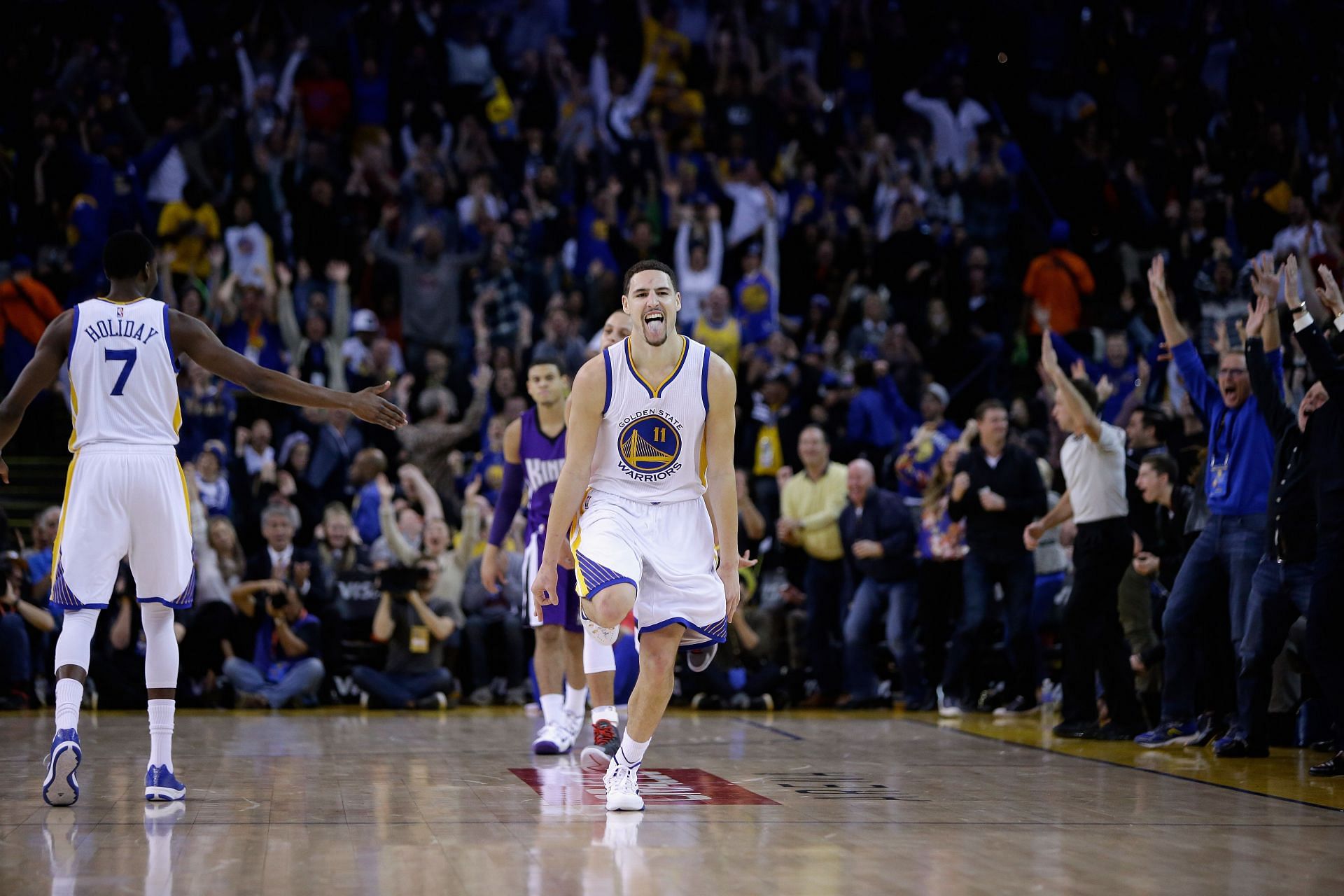 Klay Thompson #11 of the Golden State Warriors reacts after he made a three-point basket in the third quarter of their game against the Sacramento Kings at ORACLE Arena on January 23, 2015.