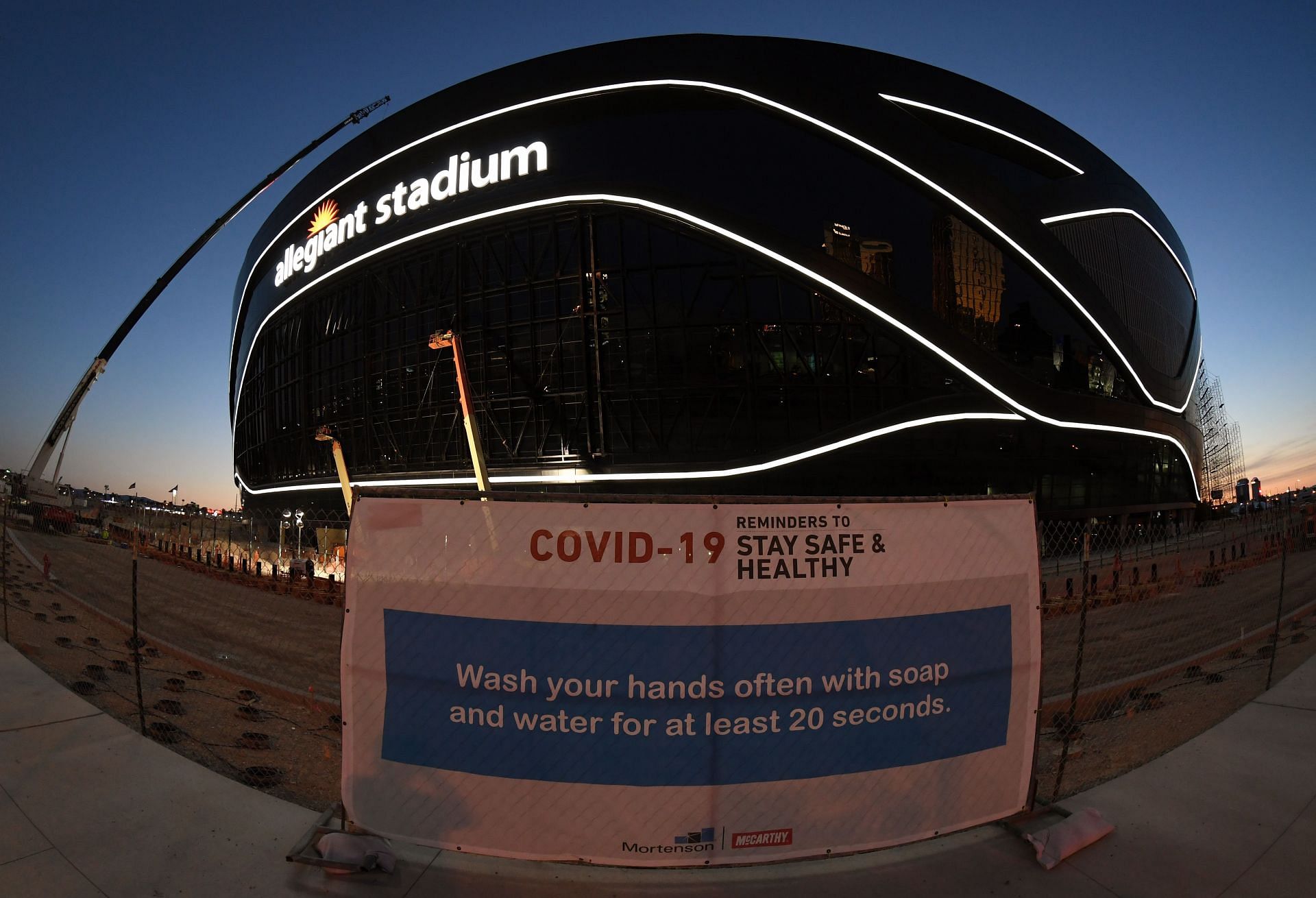 COVID-19 prevention guidelines in front of the Allegiant Stadium under construction