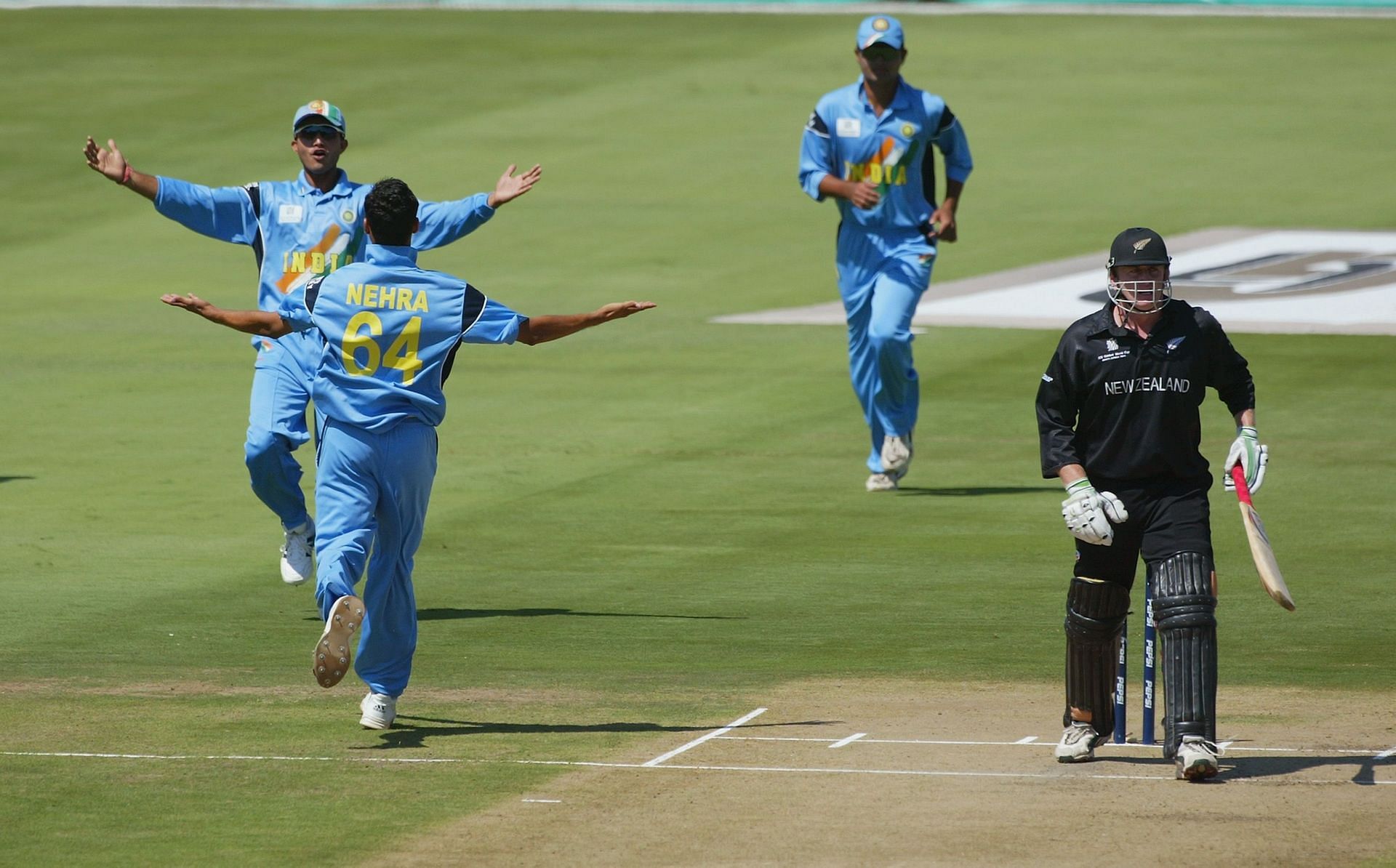 Ashish Nehra and Sourav Ganguly of India celebrate the wicket of Scott Styris of New Zealand
