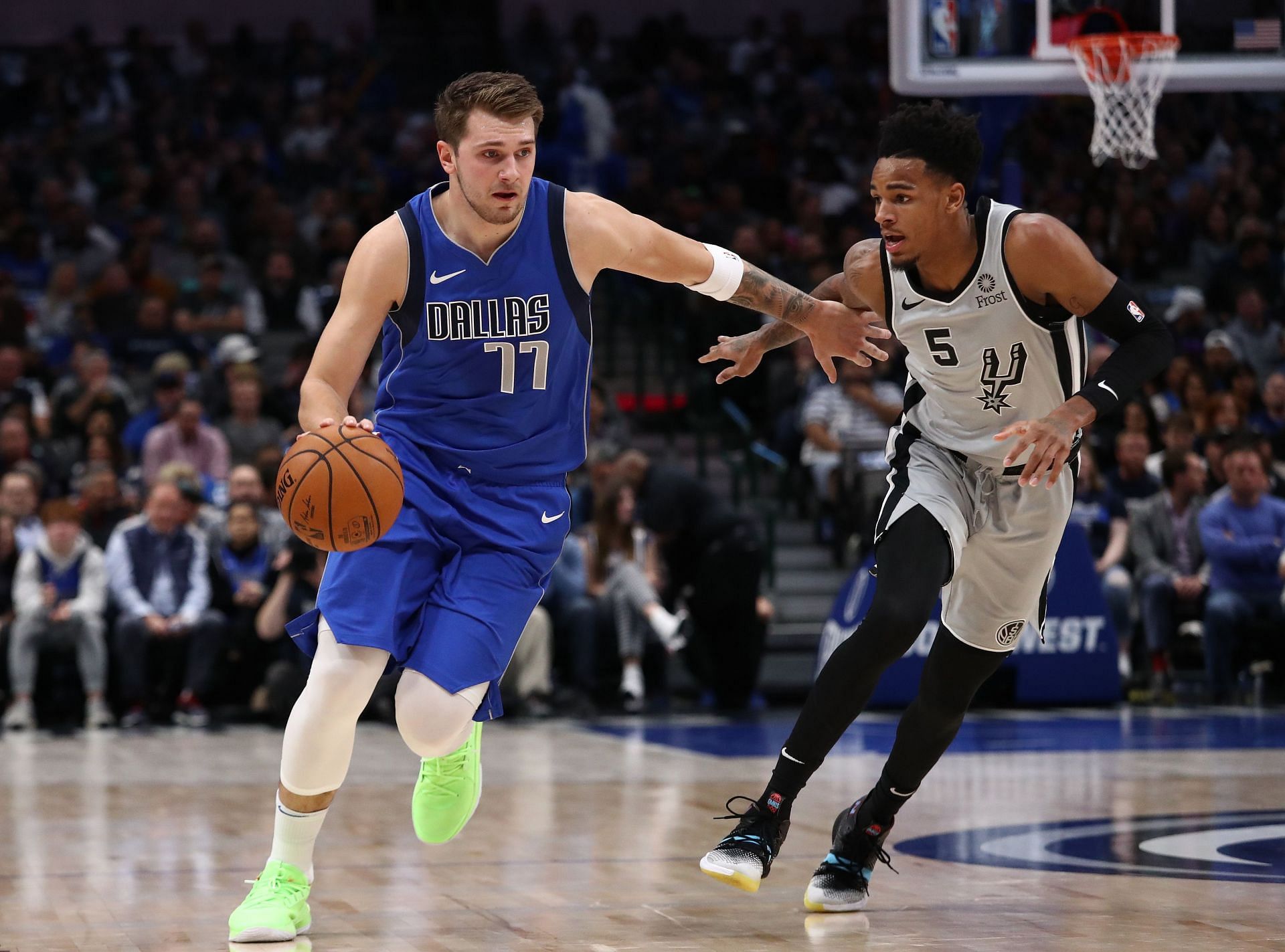 Dejounte Murray of the San Antonio Spurs defends Luka Doncic of the Dallas Mavericks.