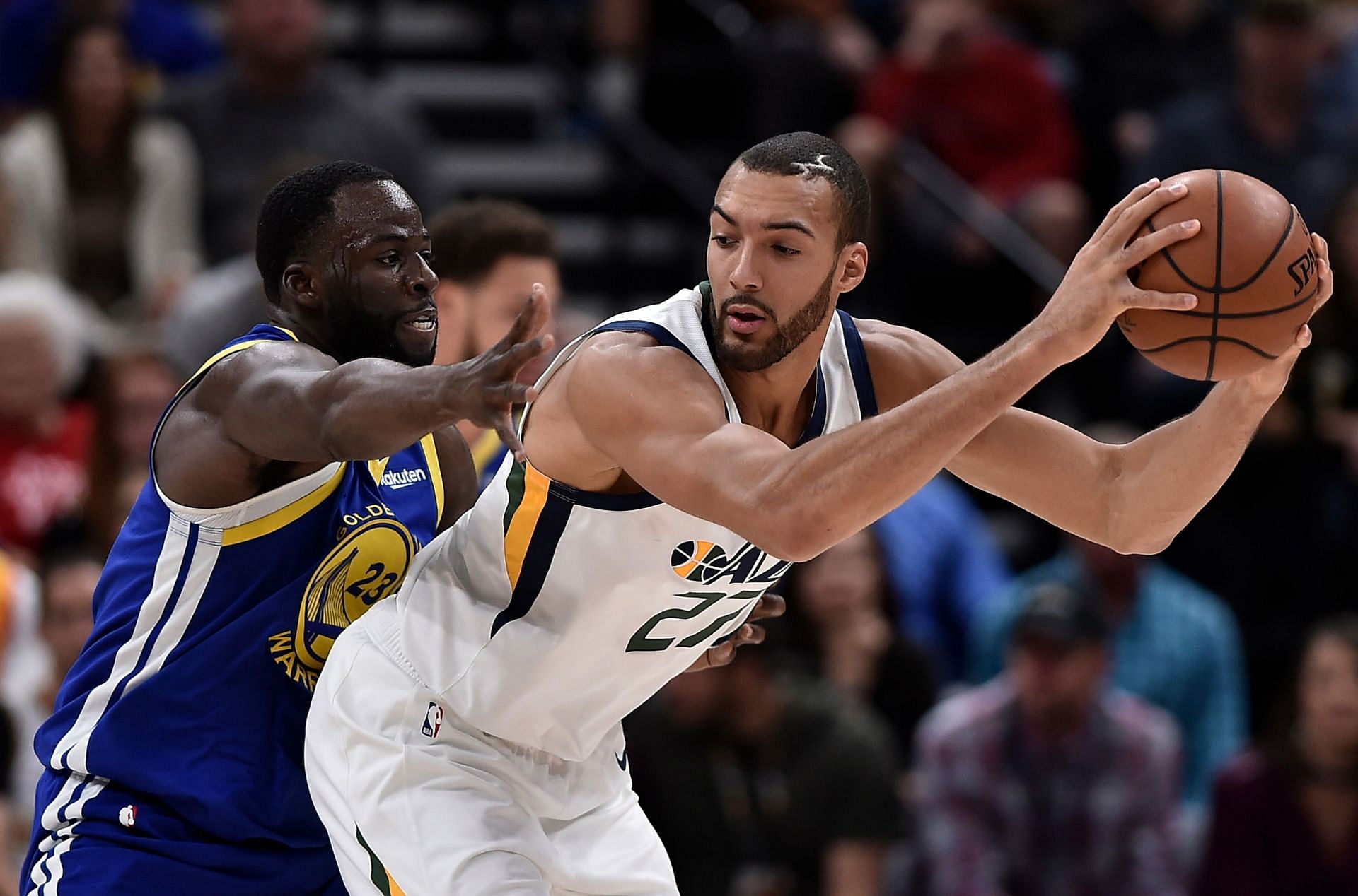 Draymond Green of the Golden State Warriors defends Rudy Gobert of the Utah Jazz.