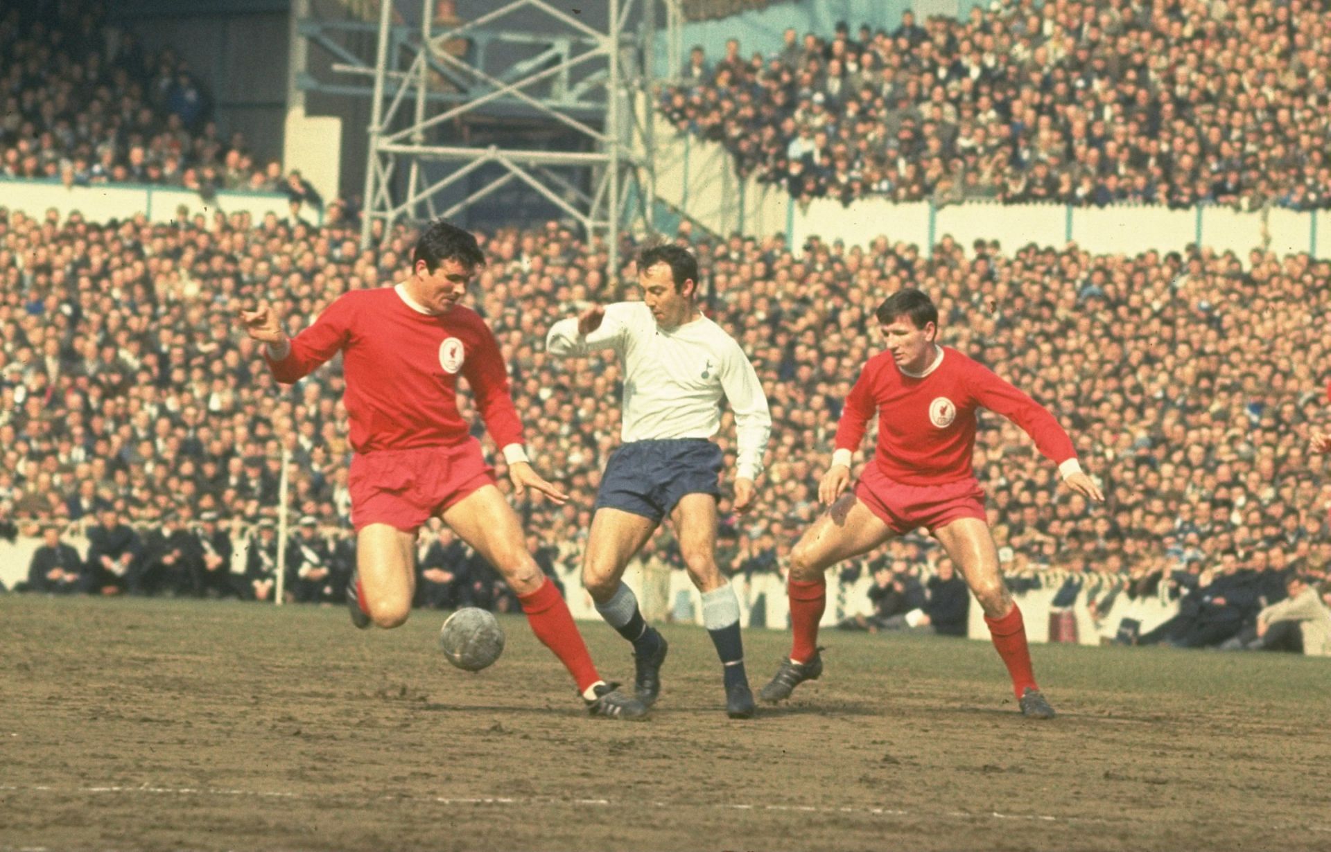 Jimmy Greaves sneaks in between Ron Yeats and Tommy Smith to take the ball