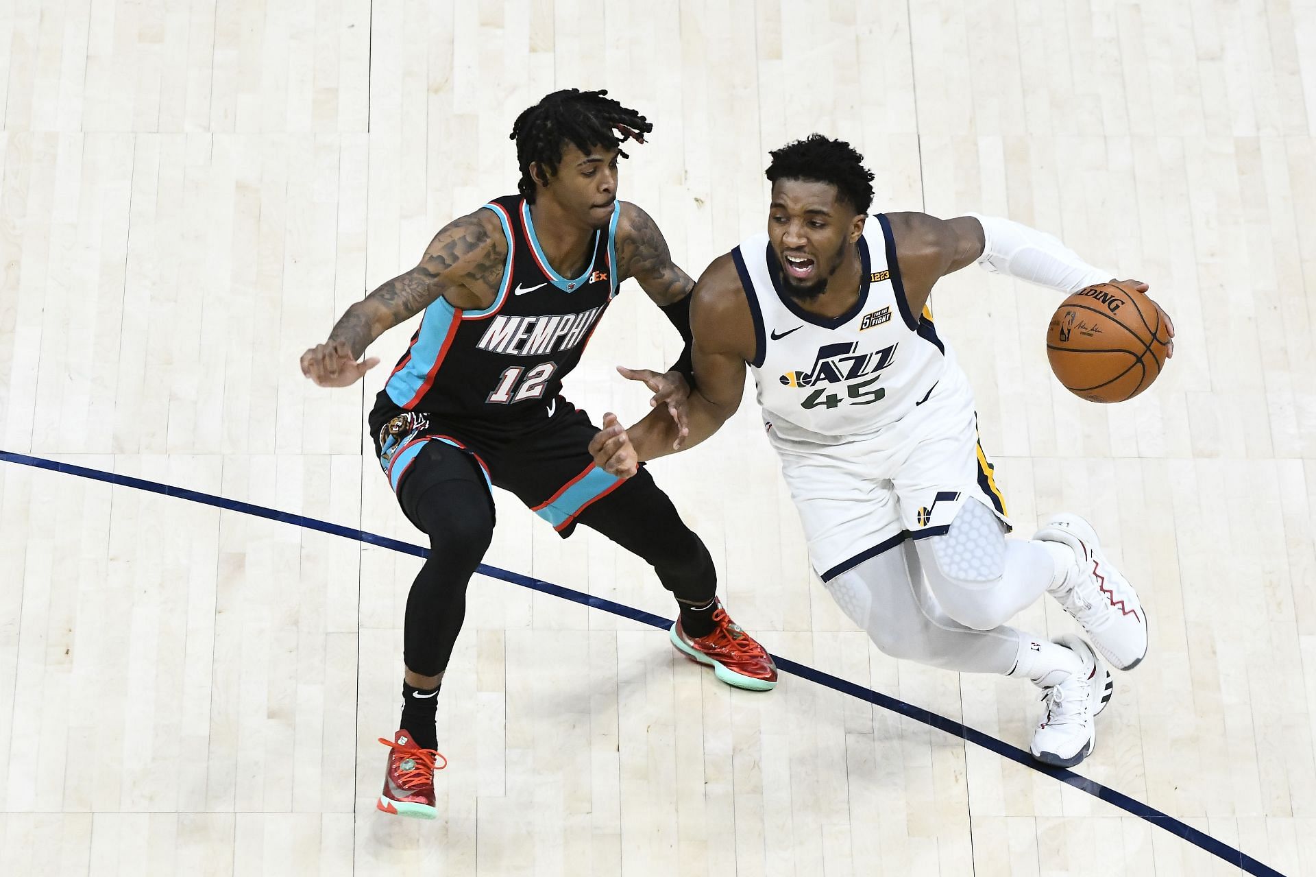 Donovan Mitchell of the Utah Jazz drives against Ja Morant of the Memphis Grizzlies