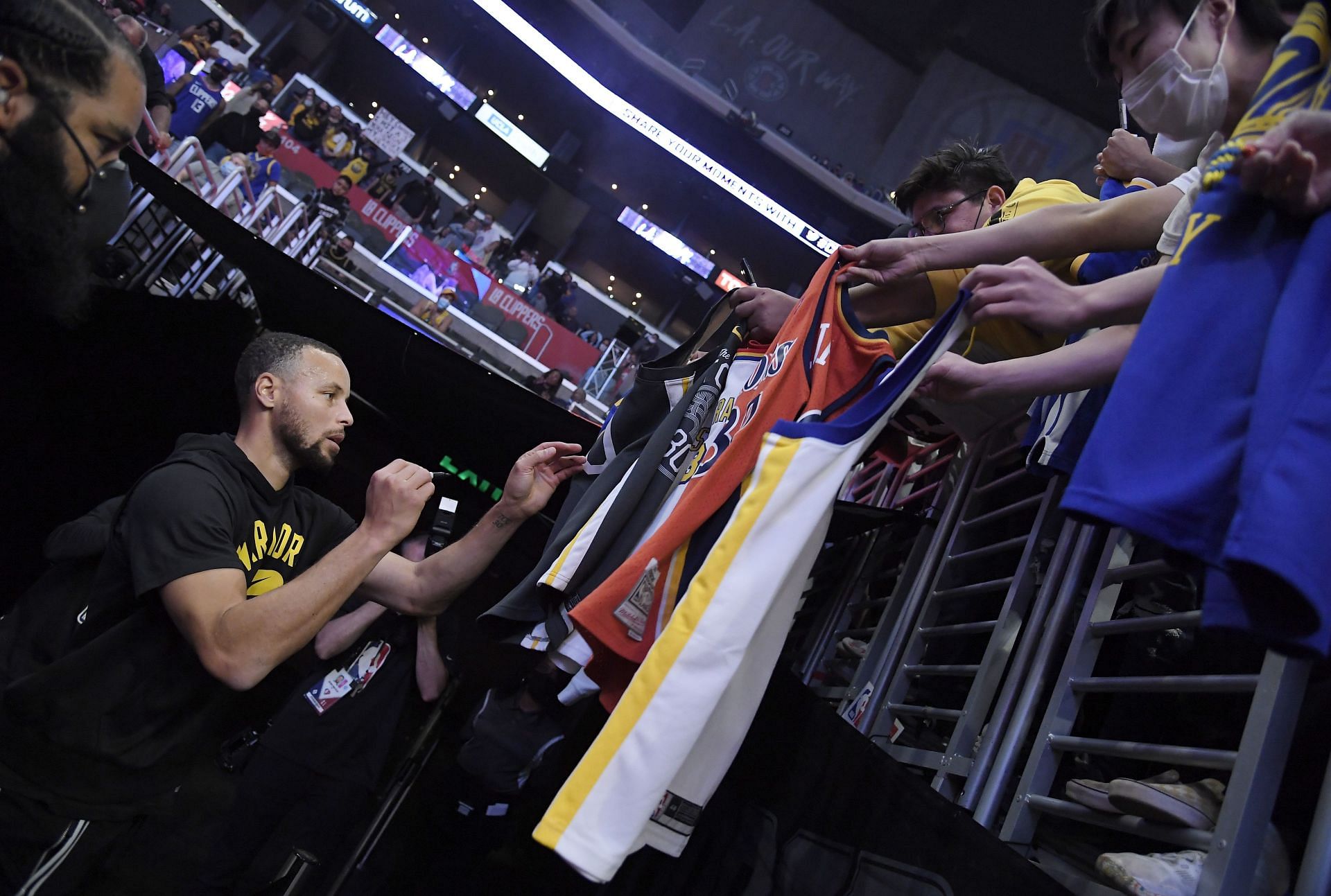 Stephen Curry of the Golden State Warriors signs jerseys at Staples Center