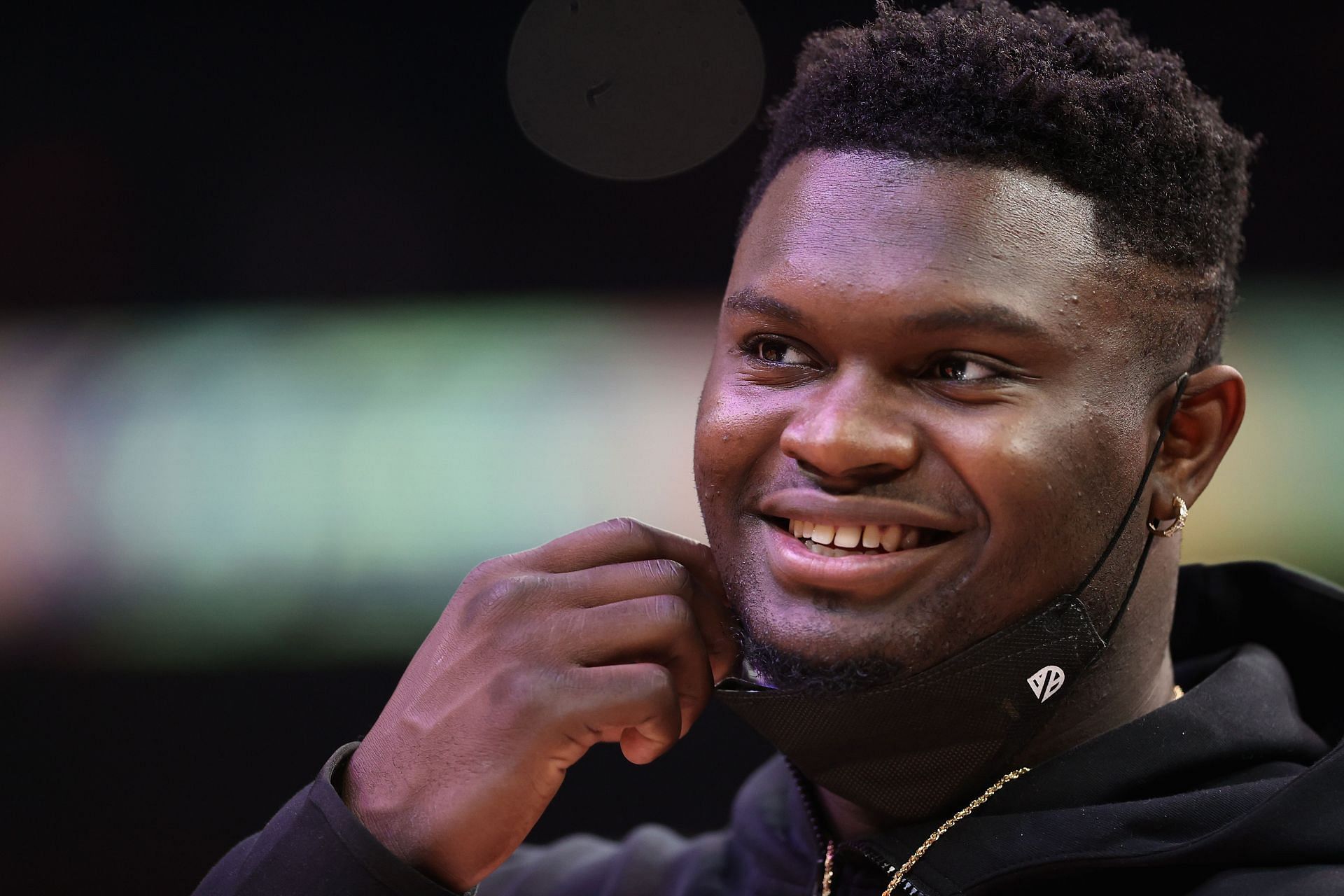 Zion Williamson of the New Orleans Pelicans supports his team from the bench.