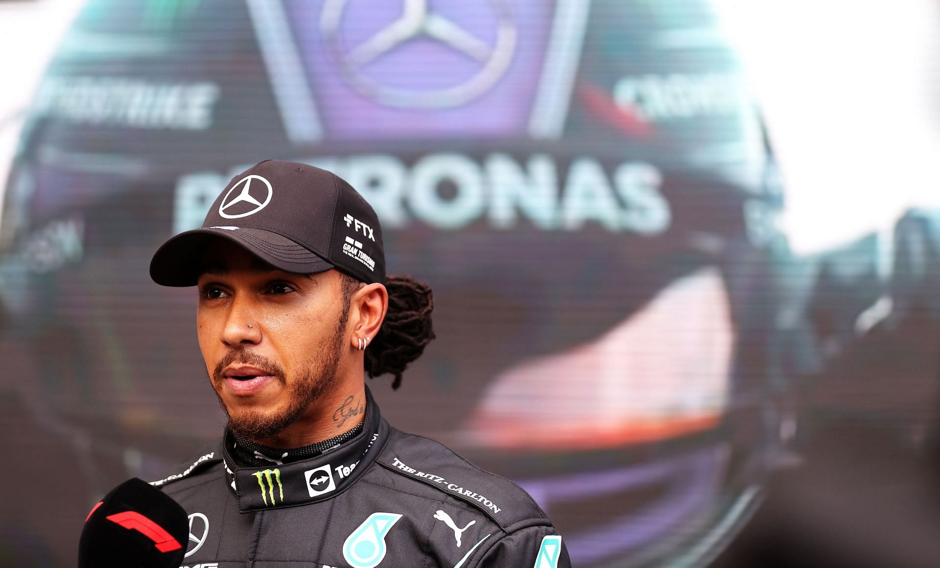 Fastest qualifier Lewis Hamilton talks to the media in parc ferme during qualifying ahead of the 2021 Brazil GP. (Photo by Lars Baron/Getty Images)