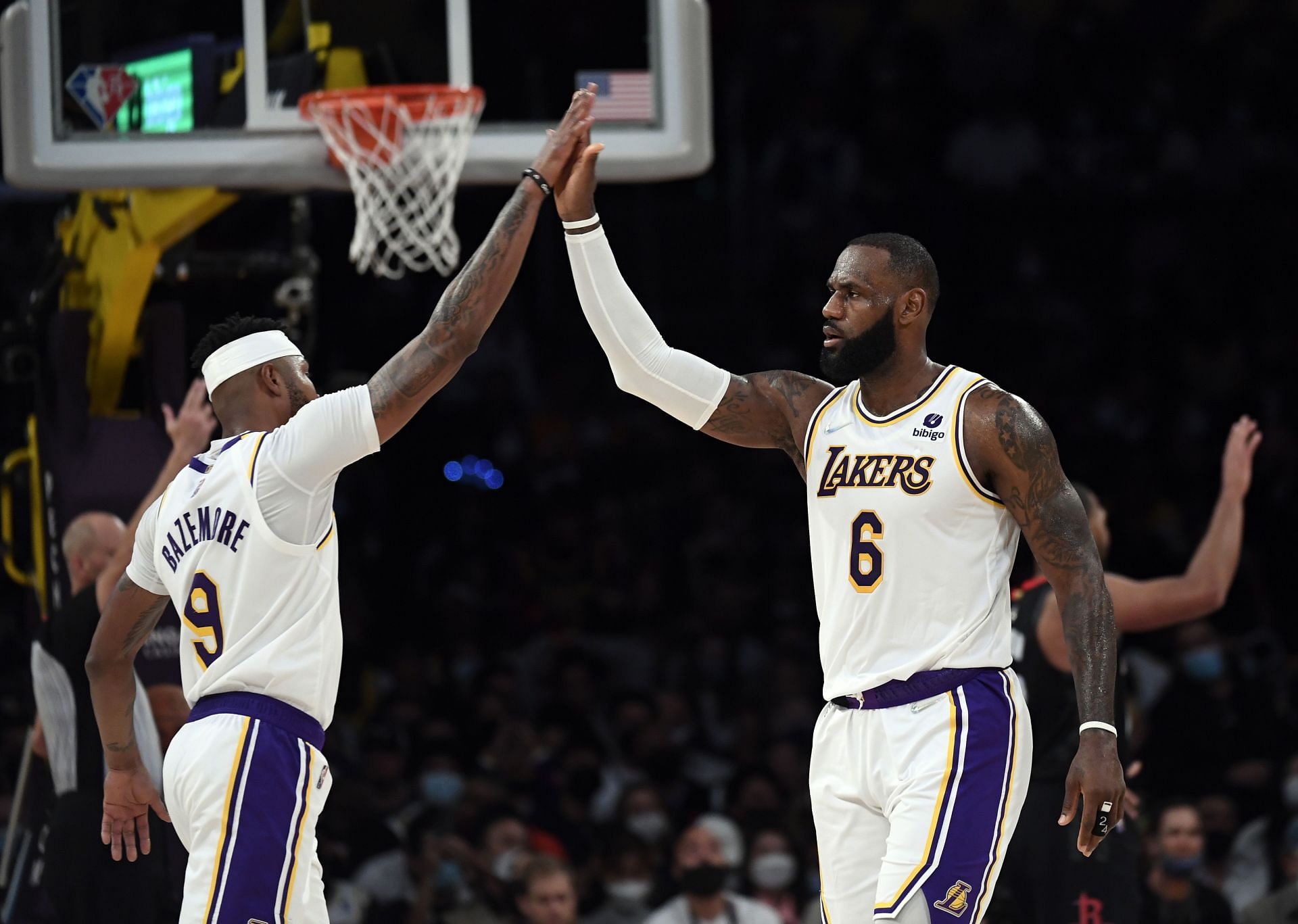 LeBron James #6 of the Los Angeles Lakers high fives Kent Bazemore #9 after scoring a basket against the Houston Rockets during the first half at Staples Center on October 31, 2021 in Los Angeles, California.