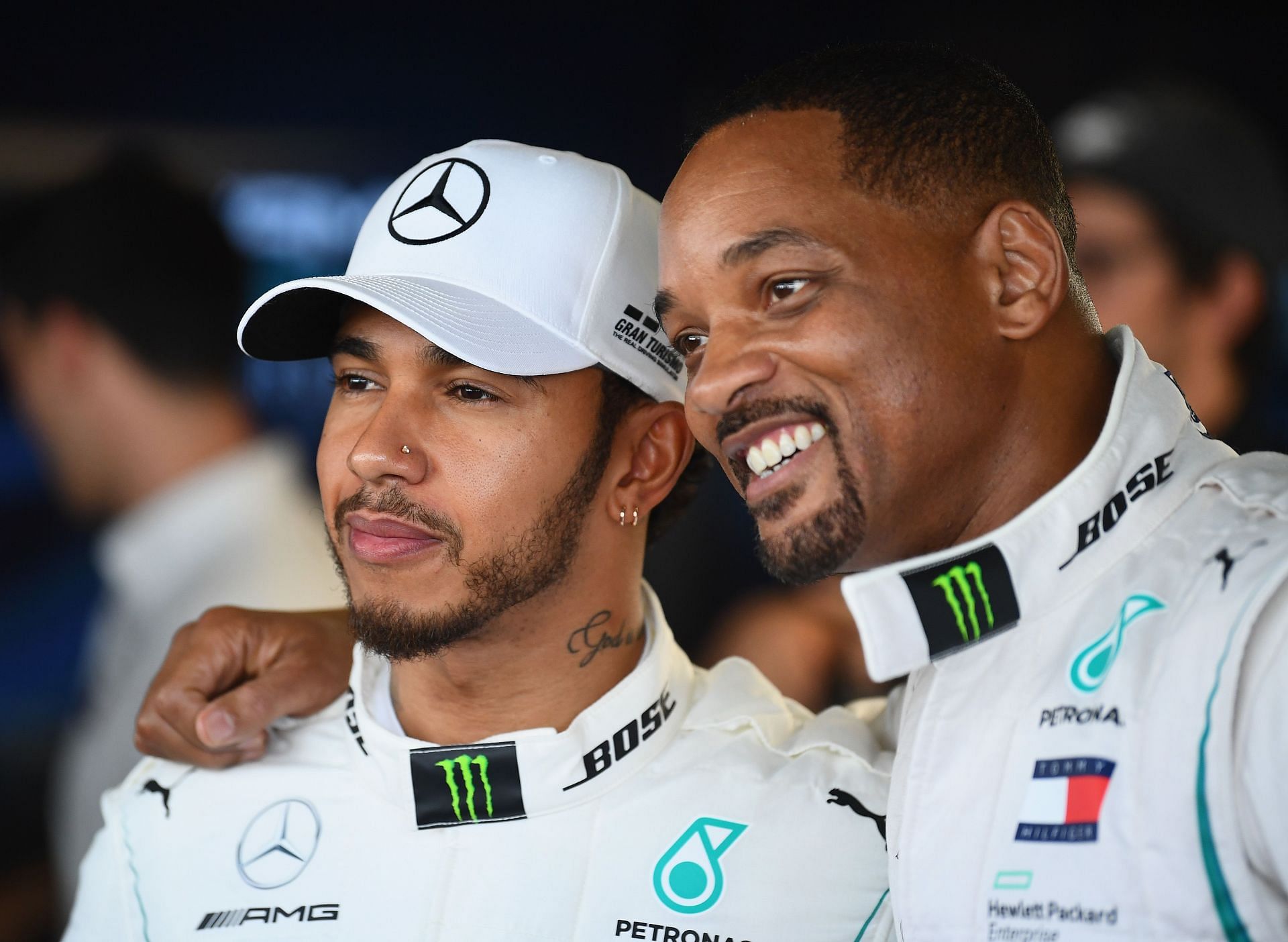 Lewis Hamilton poses with Will Smith in the paddock.