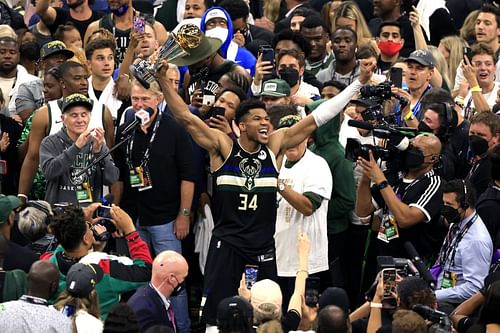 Giannis Antetokounmpo holds his 2021 NBA Finals MVP trophy proudly.