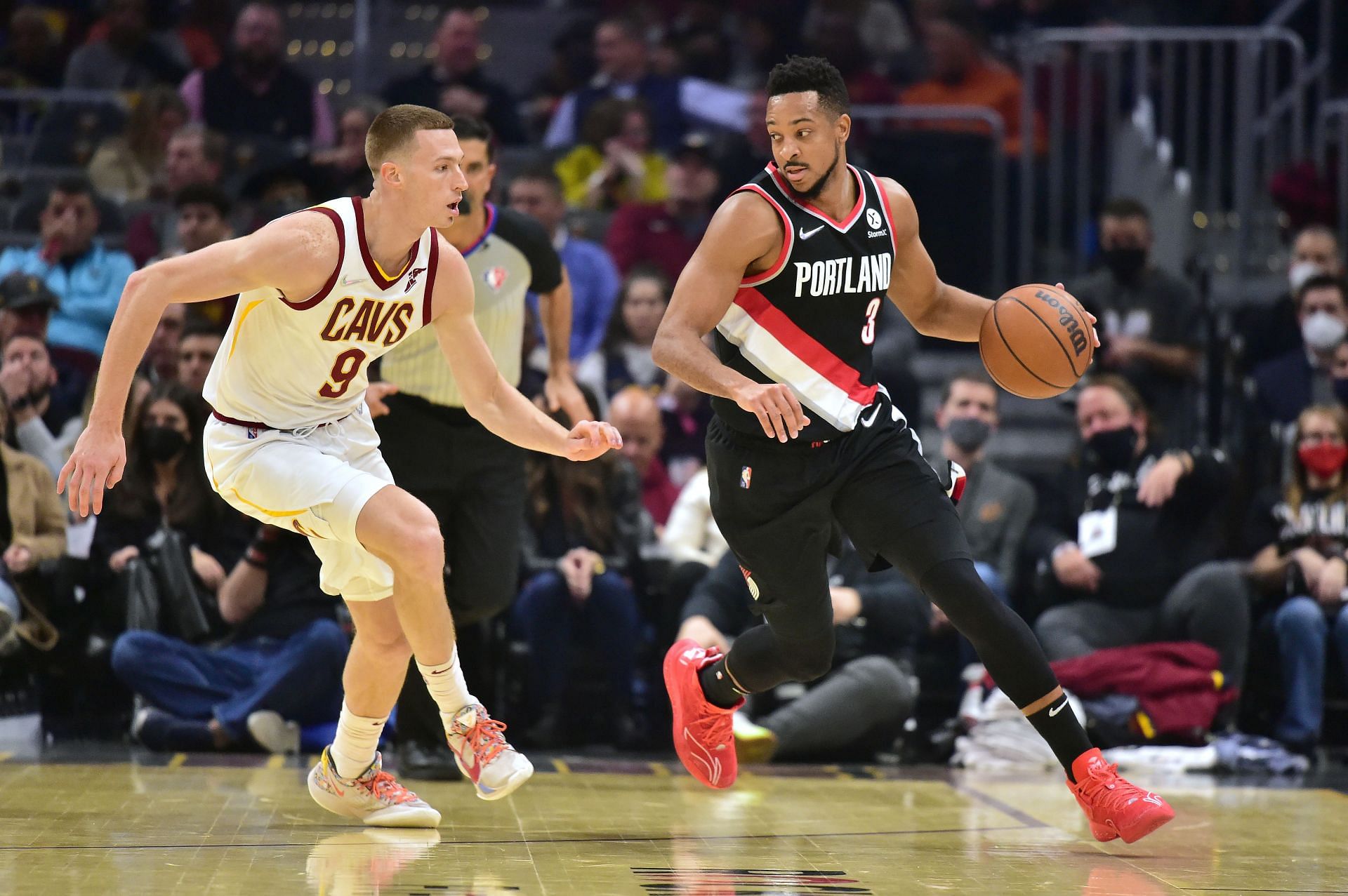 CJ McCollum #3 of the Portland Trail Blazers drives up court against Dylan Windler #9 of the Cleveland Cavaliers during the first half at Rocket Mortgage Fieldhouse on November 03, 2021 in Cleveland, Ohio.