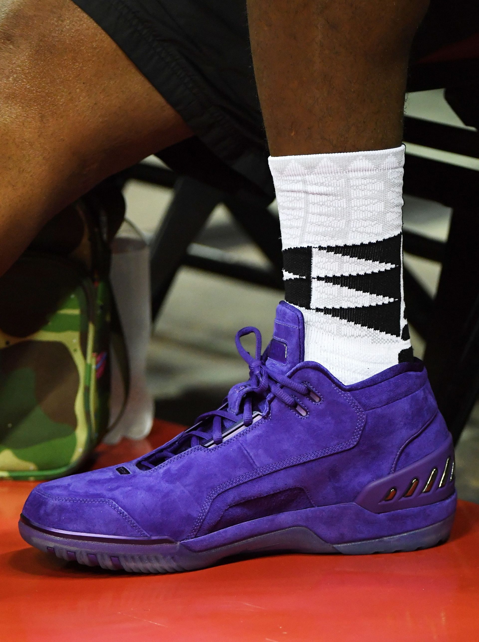 LeBron James of the Los Angeles Lakers wears purple suede Nike Air Zoom Generation sneakers