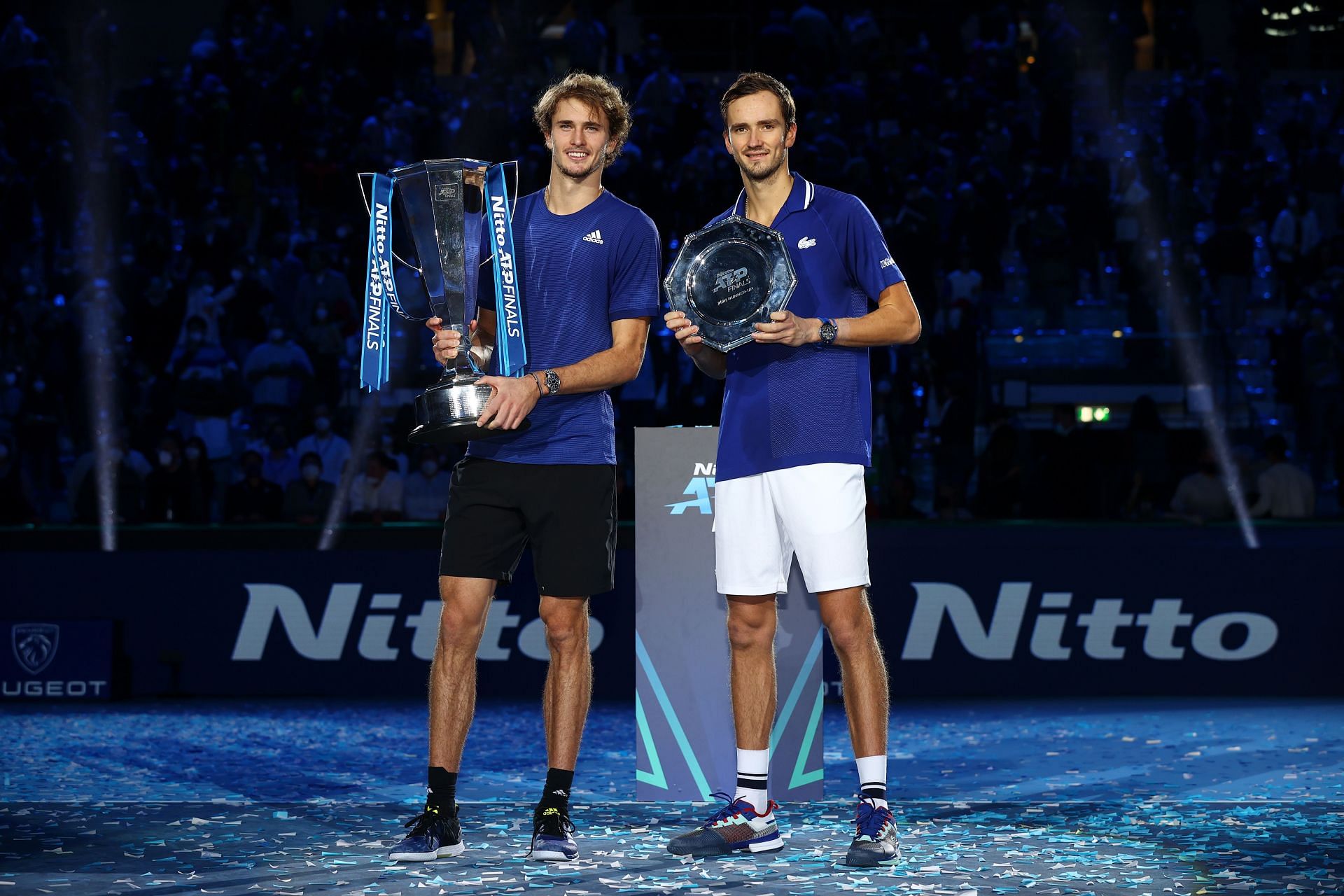 Alexander Zverev holds the trophy alongside Daniil Medvedev who holds the runners up plate after the Men's Single's Final at the Nitto ATP World Tour Finals at Pala Alpitour in Turin, Italy