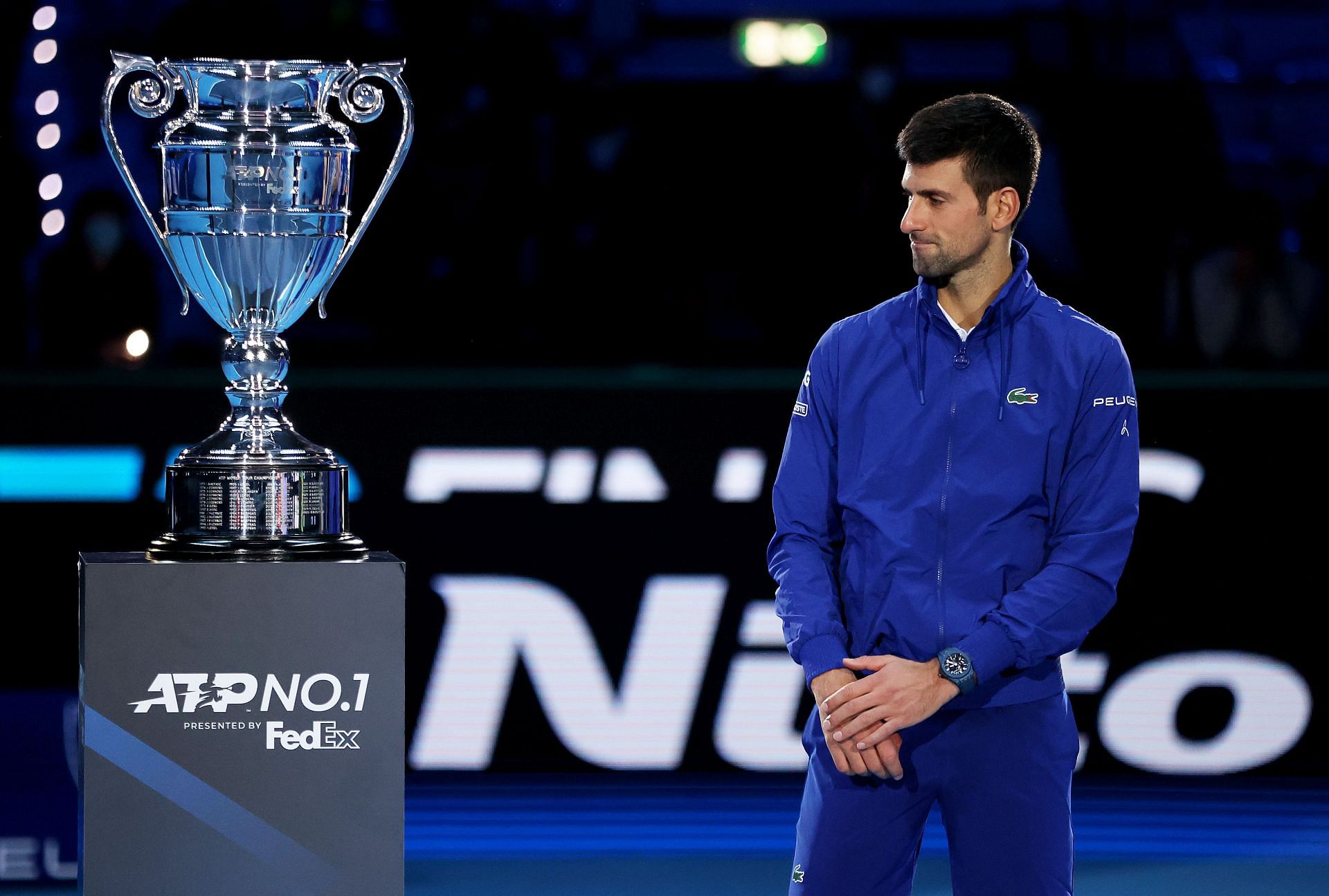 Novak Djokovic stands beside his Year-End No. 1 title