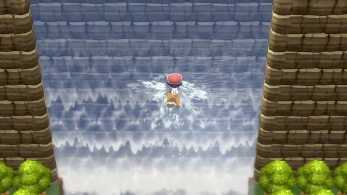 A trainer is climbing a waterfall (Image via ILCA)