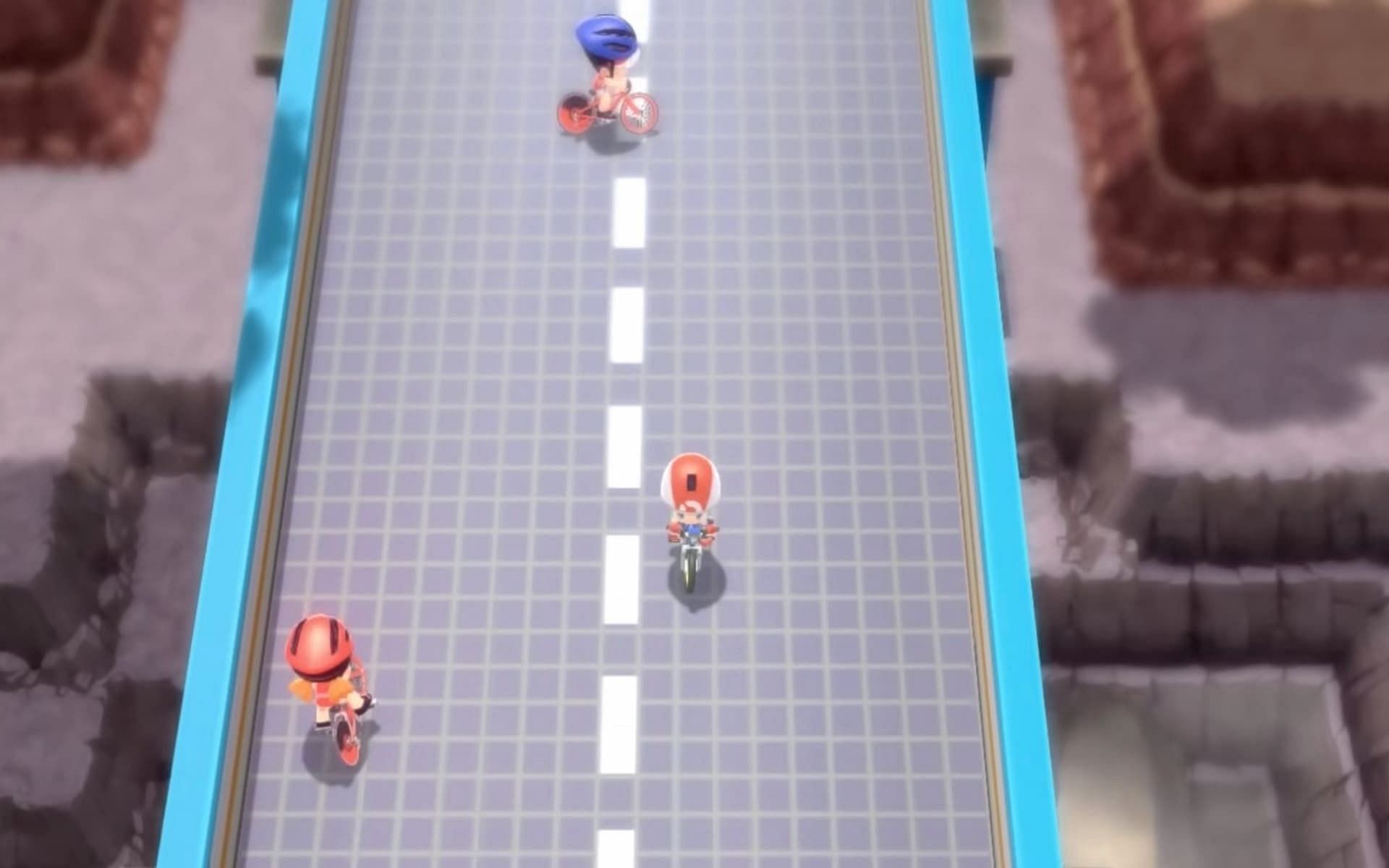 A trainer riding down Cycling Road in Pokemon Brilliant Diamond and Shining Pearl. (Image via ILCA)