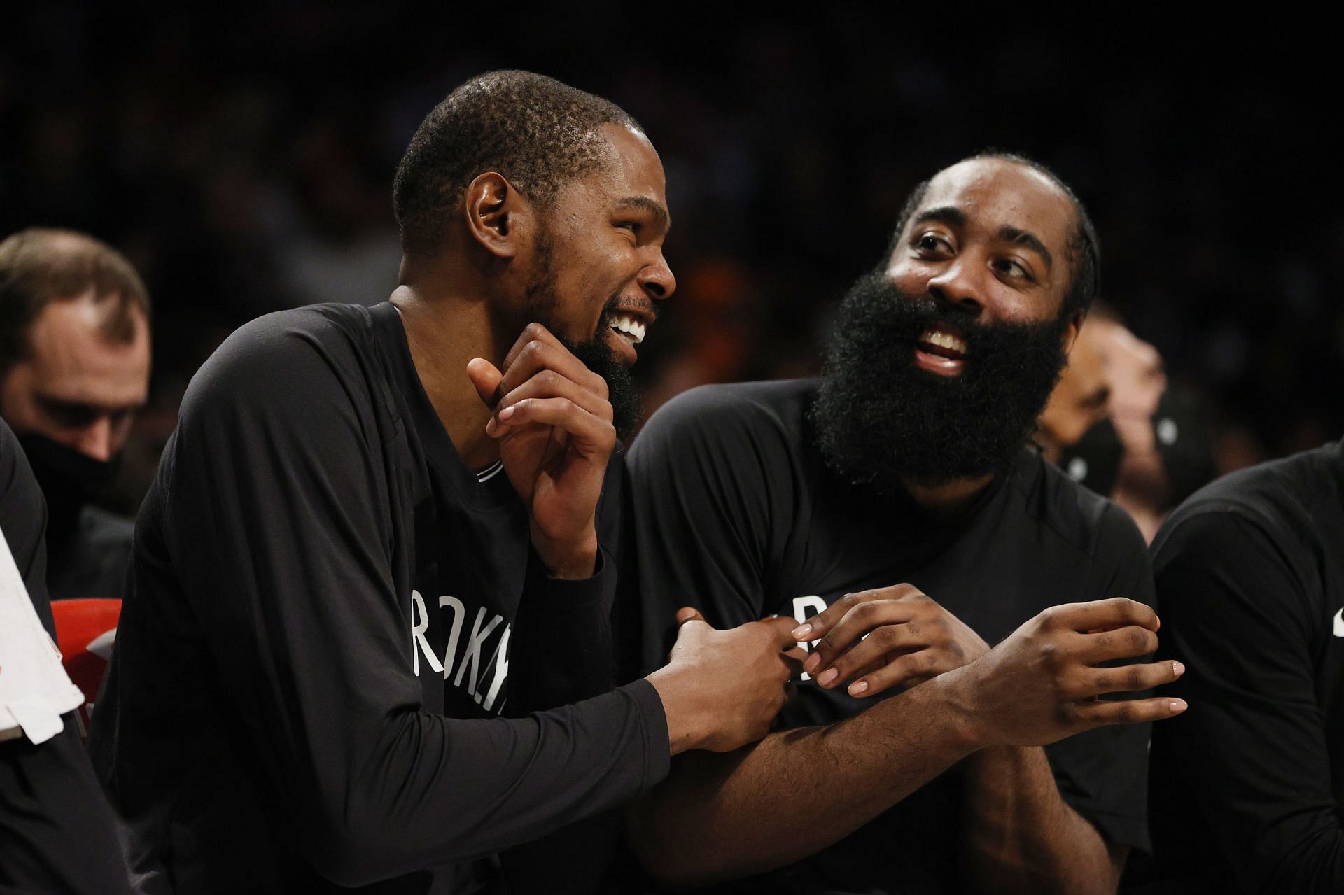 Kevin Durant #7 (L) reacts with James Harden #13 of the Brooklyn Nets (R)