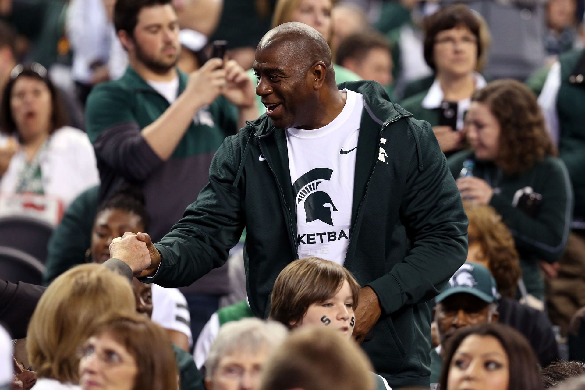 Earvin &quot;Magic&quot; Johnson talks with Michigan State Spartans fans before the Spartans take on the Duke Blue Devils in the NCAA Men&#039;s Final Four Semifinal at Lucas Oil Stadium on April 4, 2015 in Indianapolis, Indiana.