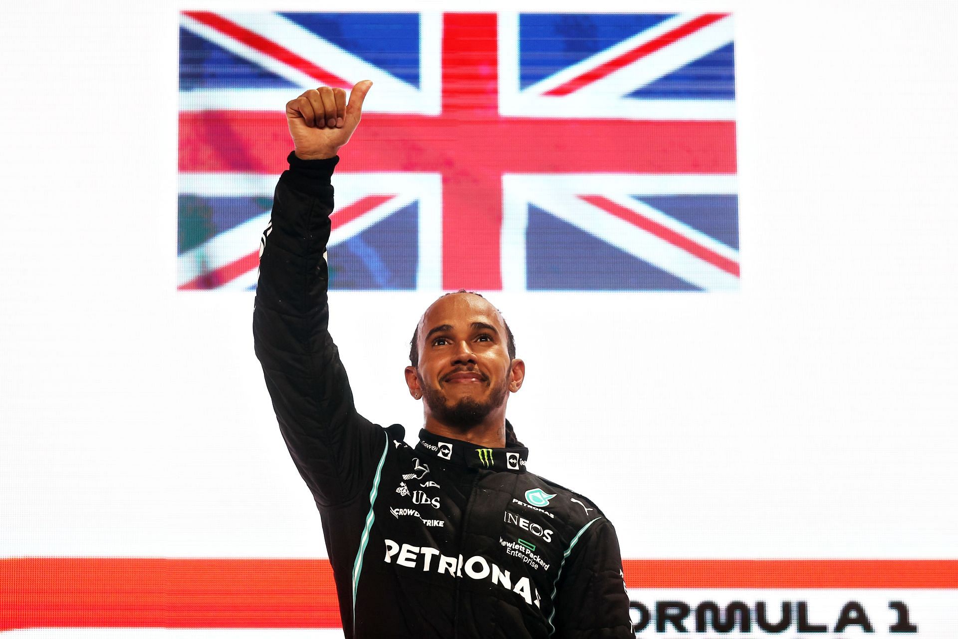 Race winner Lewis Hamilton celebrates on the podium during the Qatar Gp. (Photo by Lars Baron/Getty Images)