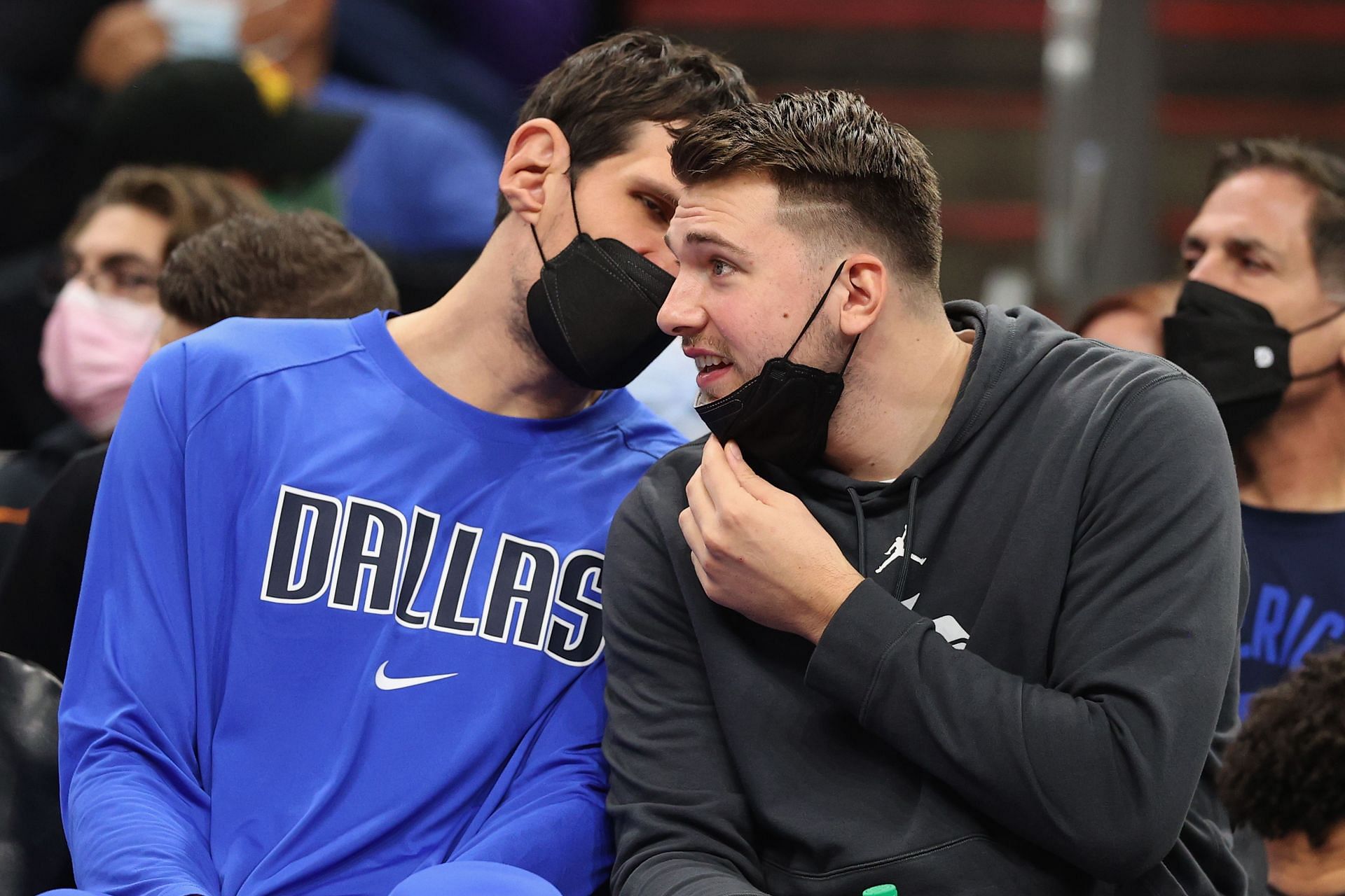 Luka Doncic of the Dallas Mavericks on the bench with Boban Marjanovic, left