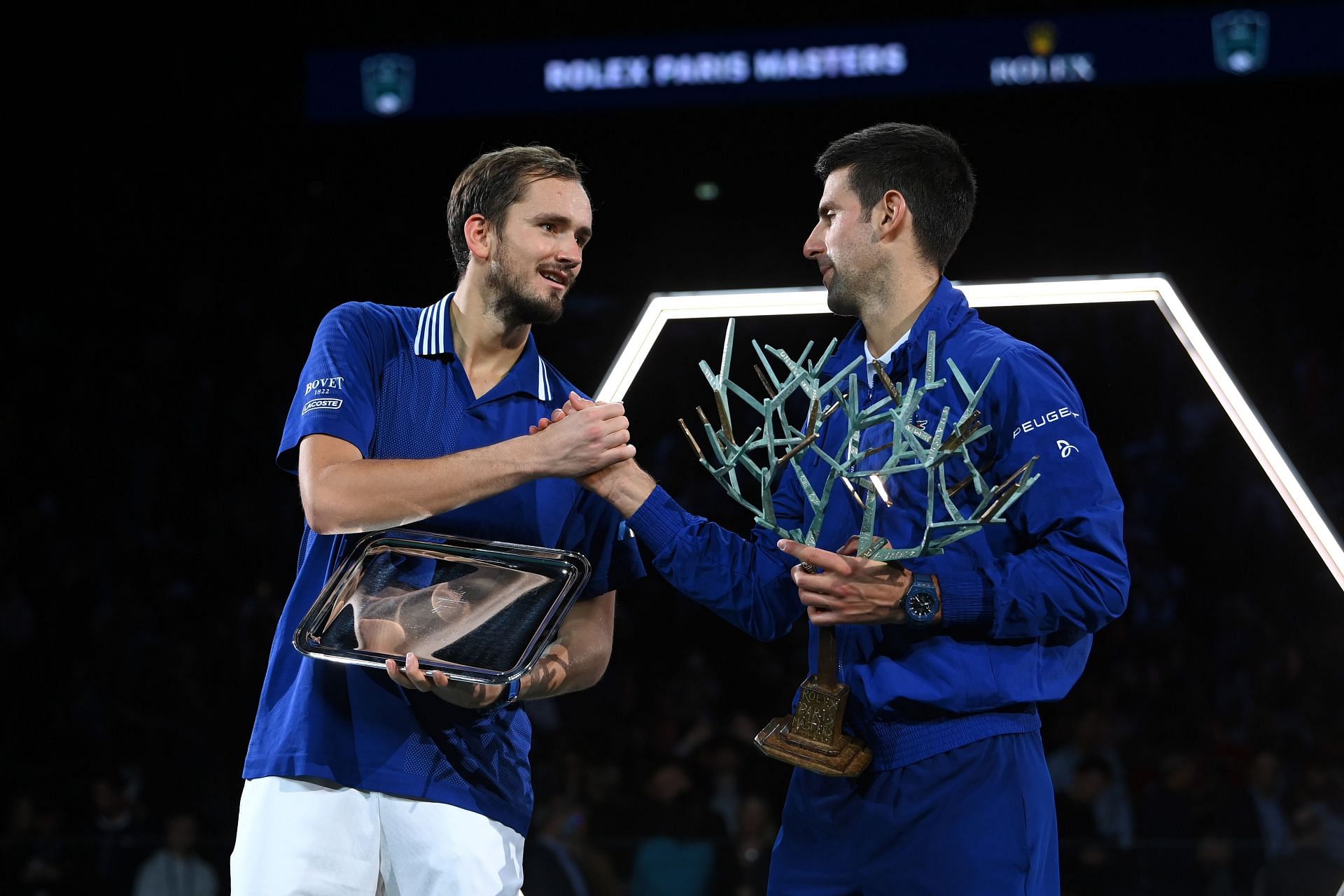 Novak Djokovic and Daniil Medvedev pose with their trophies at the Rolex Paris Masters on Sunday