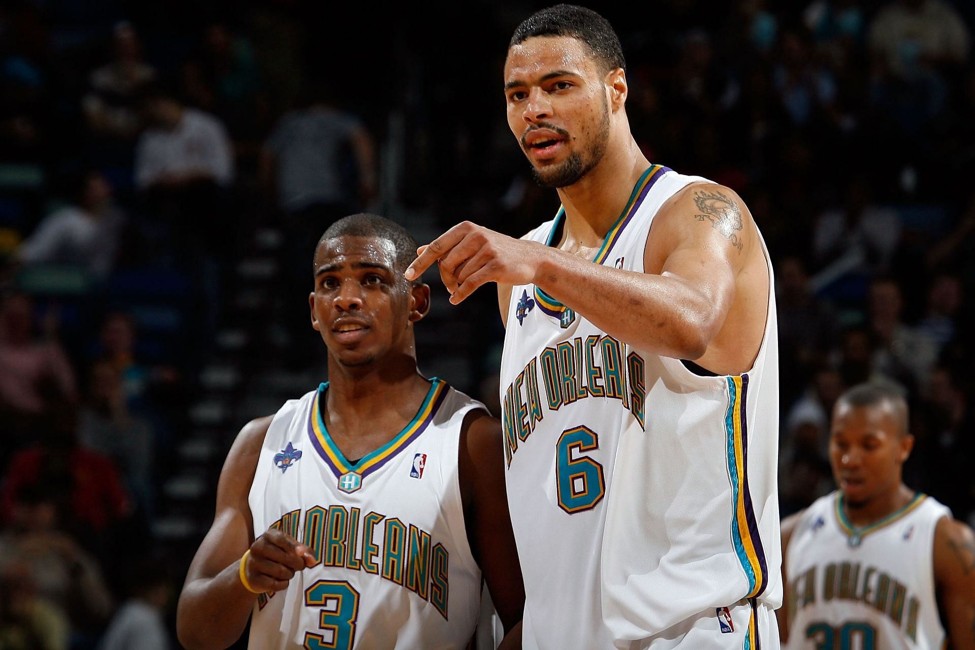 Chris Paul #3 talks with Tyson Chandler #6 of the New Orleans Hornets during the game against the Milwaukee Bucks