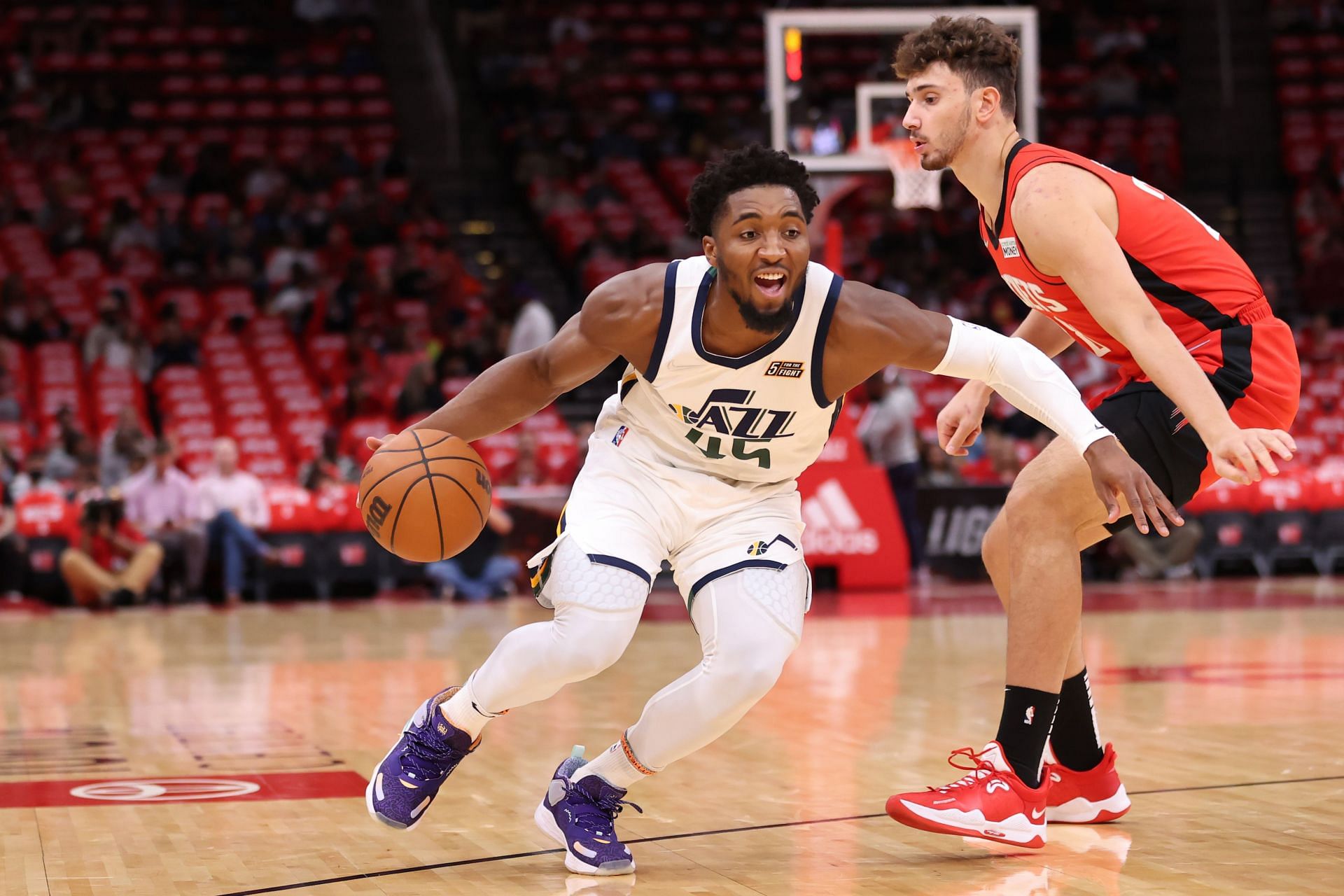 Donovan Mitchell #45 of the Utah Jazz controls the ball ahead of Alperen Sengun #28 of the Houston Rockets during the first half at Toyota Center on October 28, 2021 in Houston, Texas.