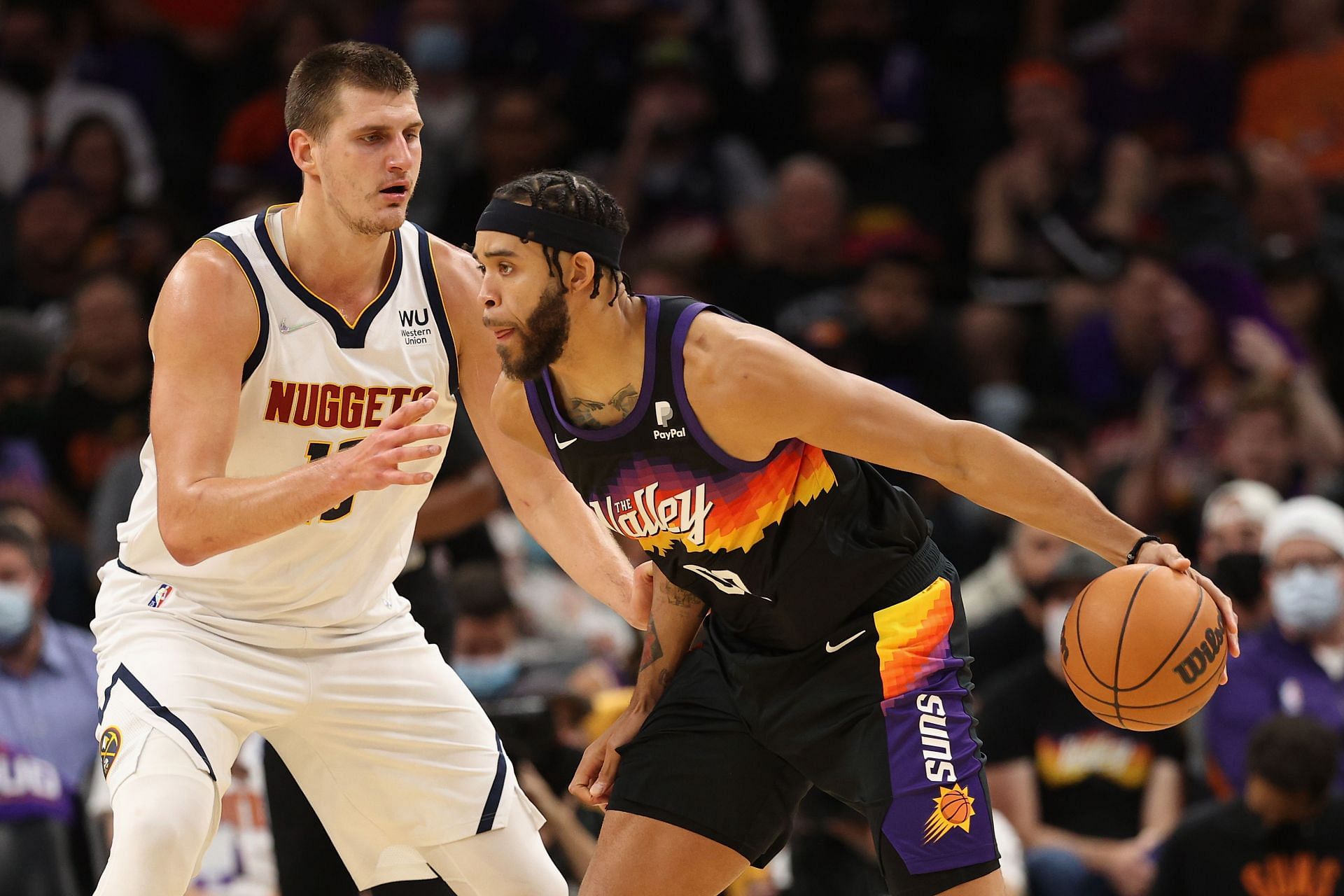 Nikola Jokic of the Denver Nuggets guards JaVale McGee of the Phoenix Suns