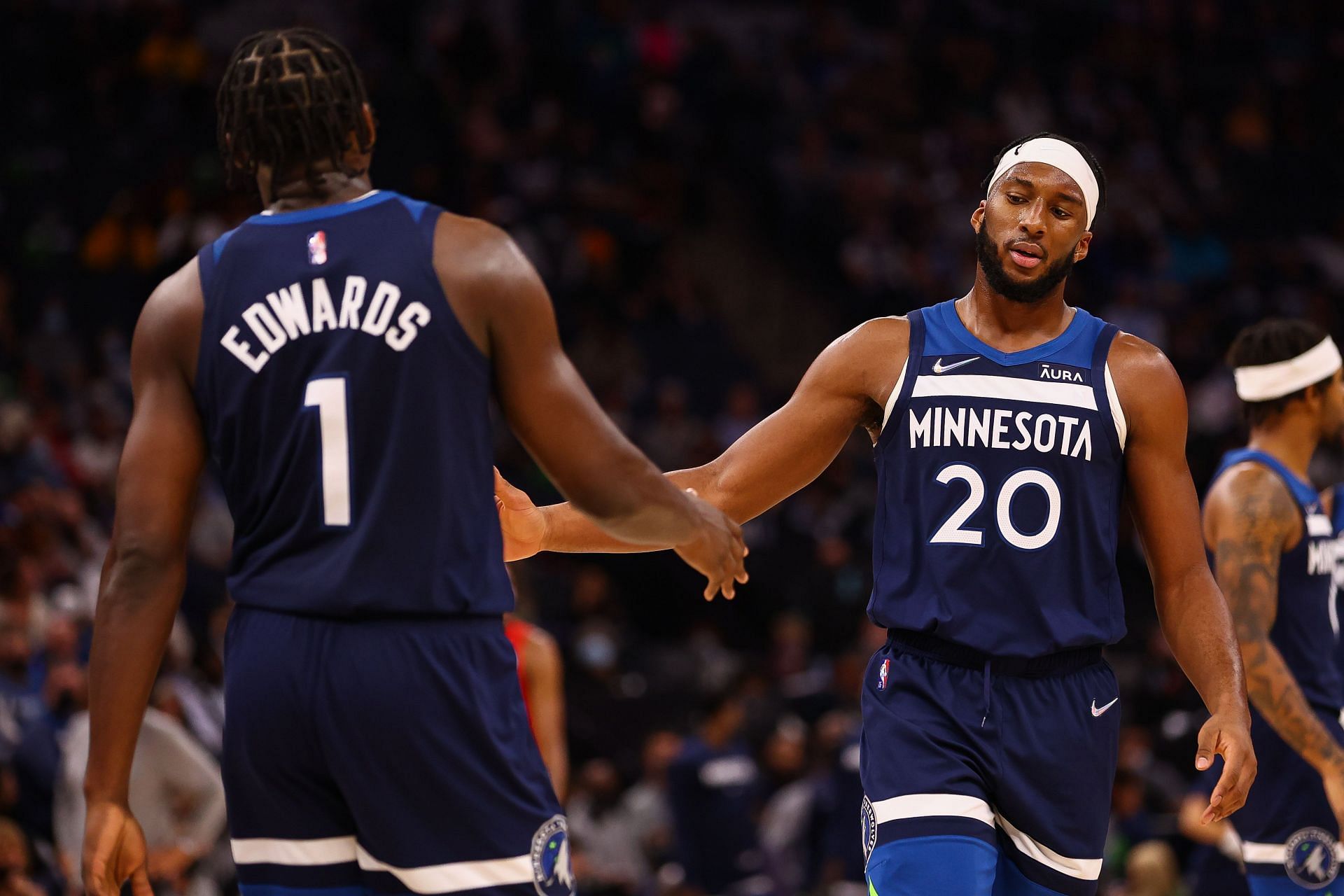 Josh Okogie #20 and Anthony Edwards #1 of the Minnesota Timberwolves celebrate after a play during the third quarter against the Houston Rockets at Target Center on October 20, 2021 in Minneapolis, Minnesota.