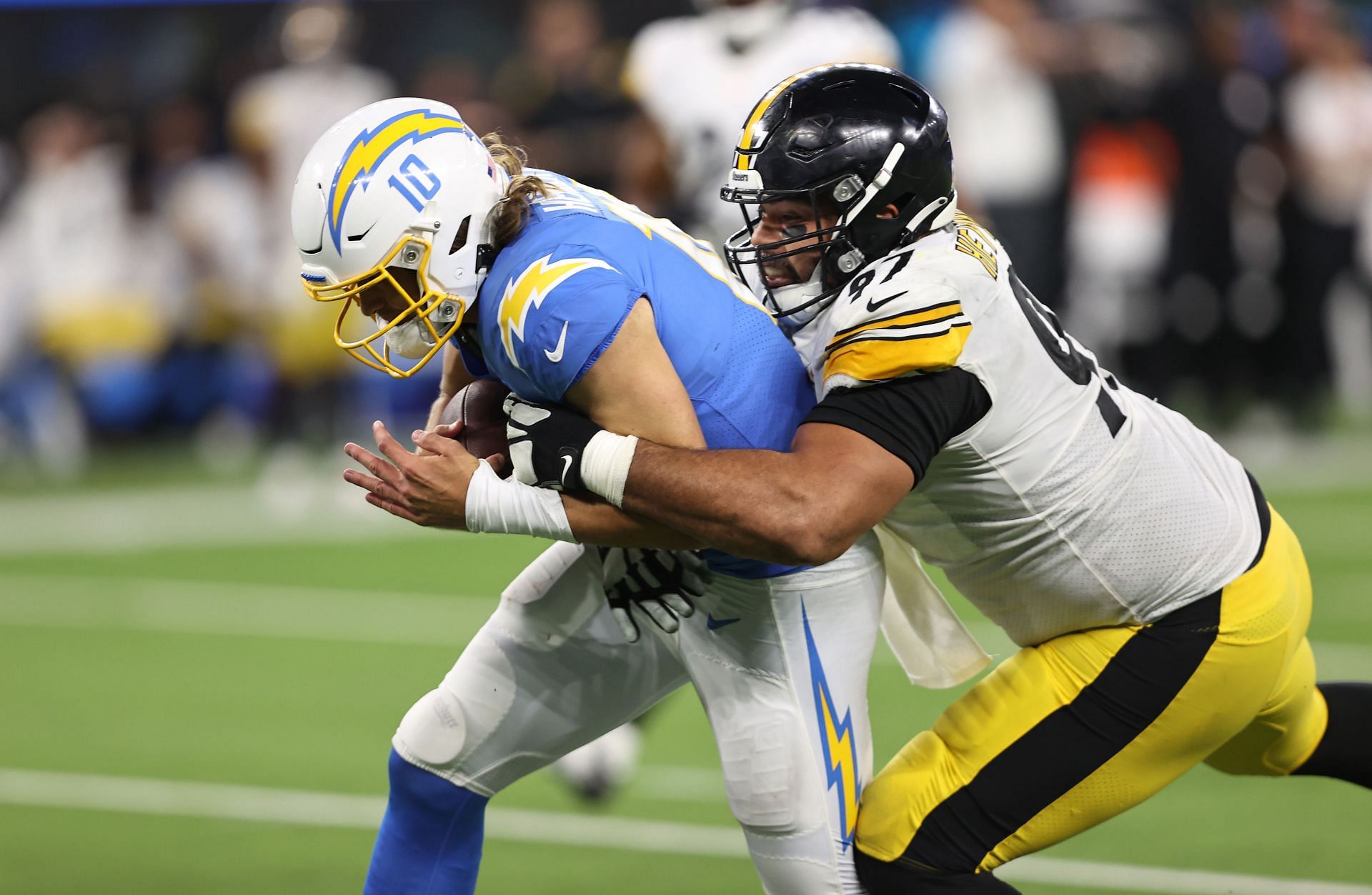 Justin Herbert is brought to the ground by Cameron Heyward.