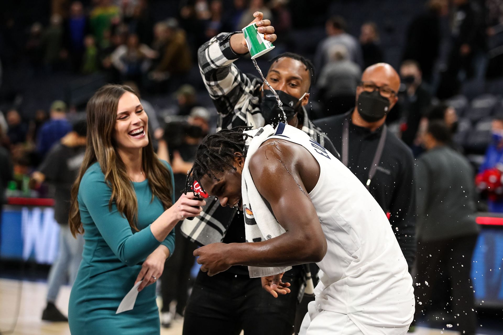 Josh Okogie #20 pours water on Anthony Edwards #1 of the Minnesota Timberwolves after the game against the Sacramento Kings