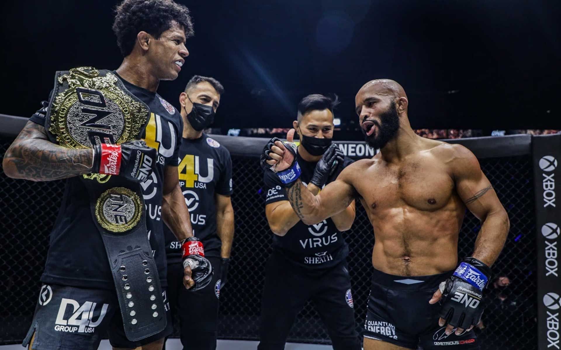 ONE flyweight world champion Adriano Moraes fist bumps MMA GOAT Demetrious Johnson following victory [Photo courtesy of ONE Championship]