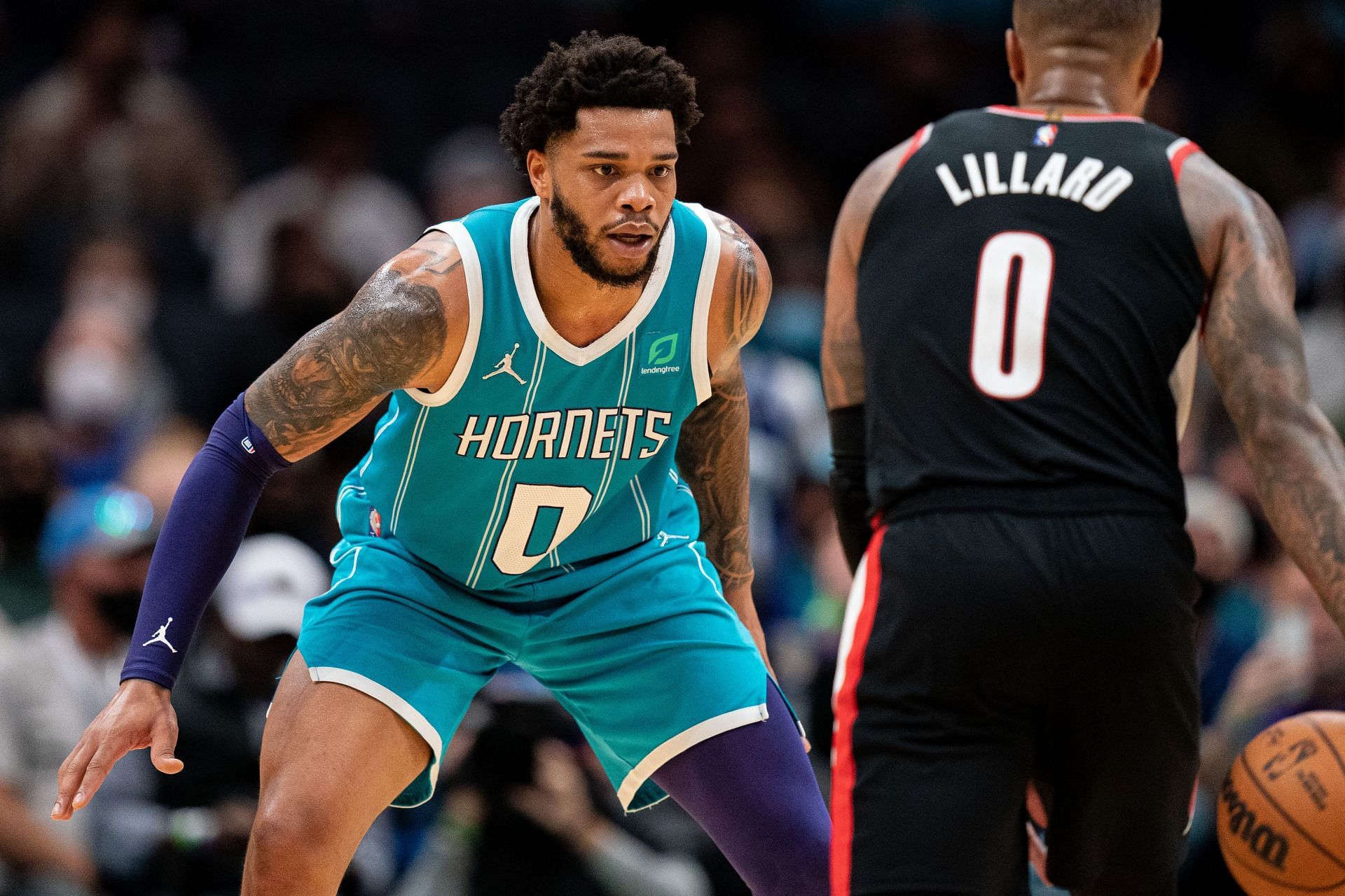 Miles Bridges #0 of the Charlotte Hornets guards Damian Lillard #0 of the Portland Trail Blazers during the fourth quarter during their game at Spectrum Center