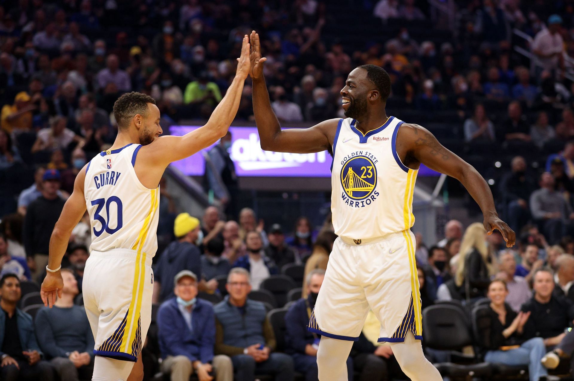 Draymond Green of the Golden State Warriors high-fives Stephen Curry (30) during the first half against the Memphis Grizzlies at Chase Center on Oct. 28, 2021, in San Francisco, Calif.