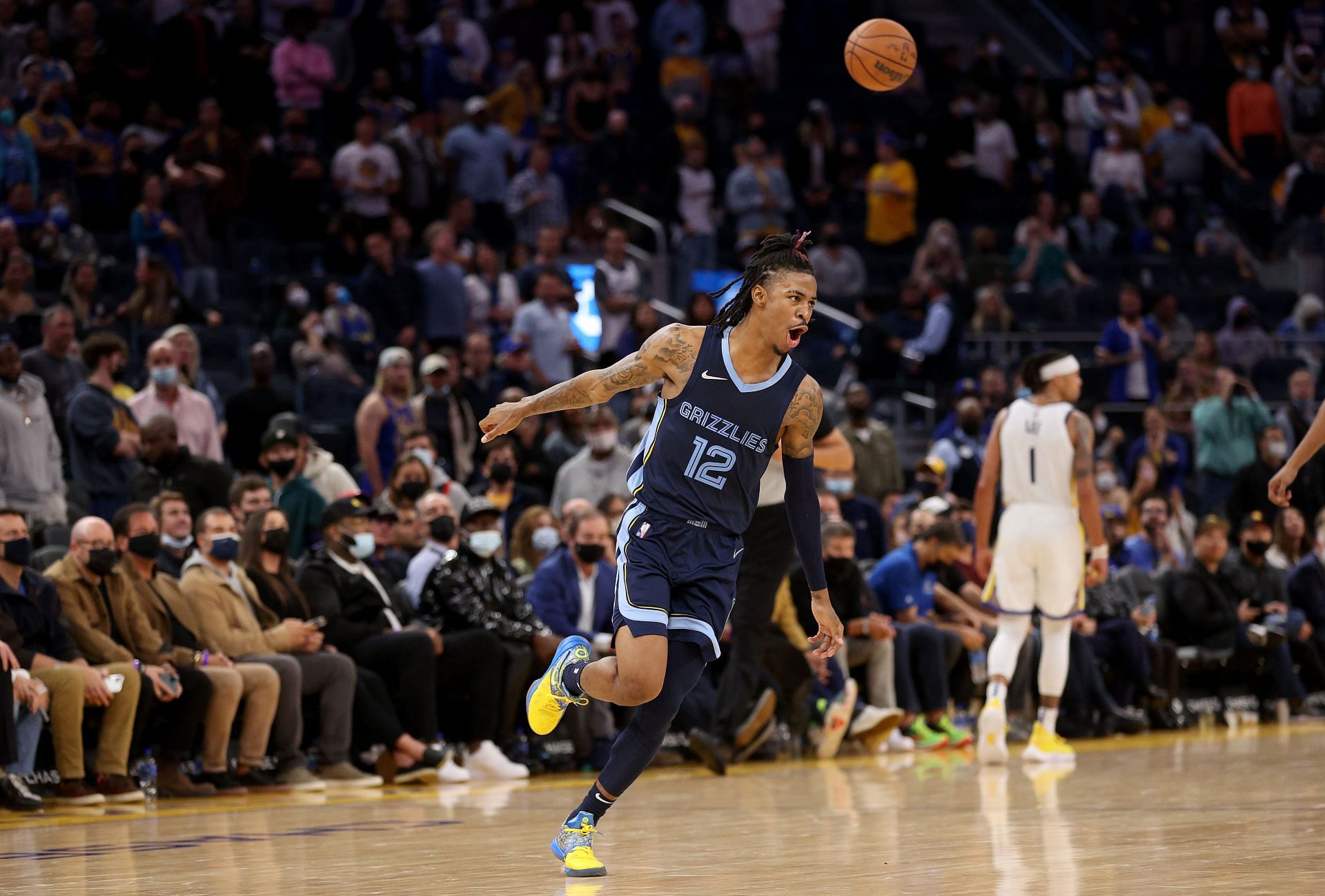 Ja Morant #12 of the Memphis Grizzlies is guarded by Stephen Curry #30 of the Golden State Warriors at Chase Center on October 28, 2021 in San Francisco, California.