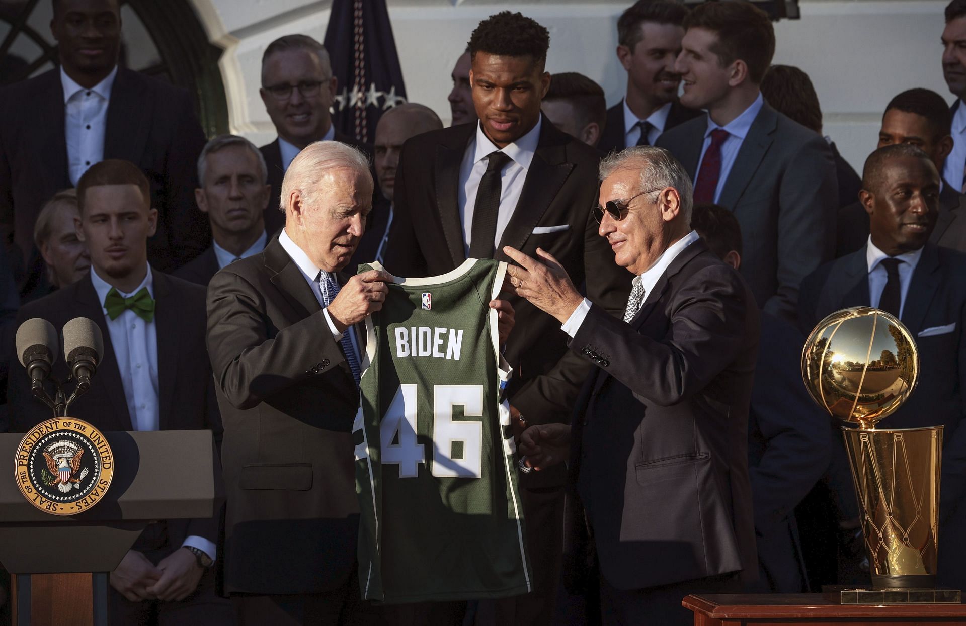 U.S. President Joe Biden (L) honors the NBA Champions, Milwaukee Bucks and receives a jersey from Milwaukee Bucks owner Marc Lasry (R).
