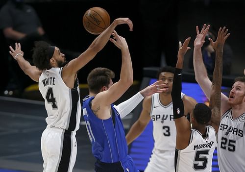 The San Antonio Spurs swarms Luka Doncic of the Dallas Mavericks.