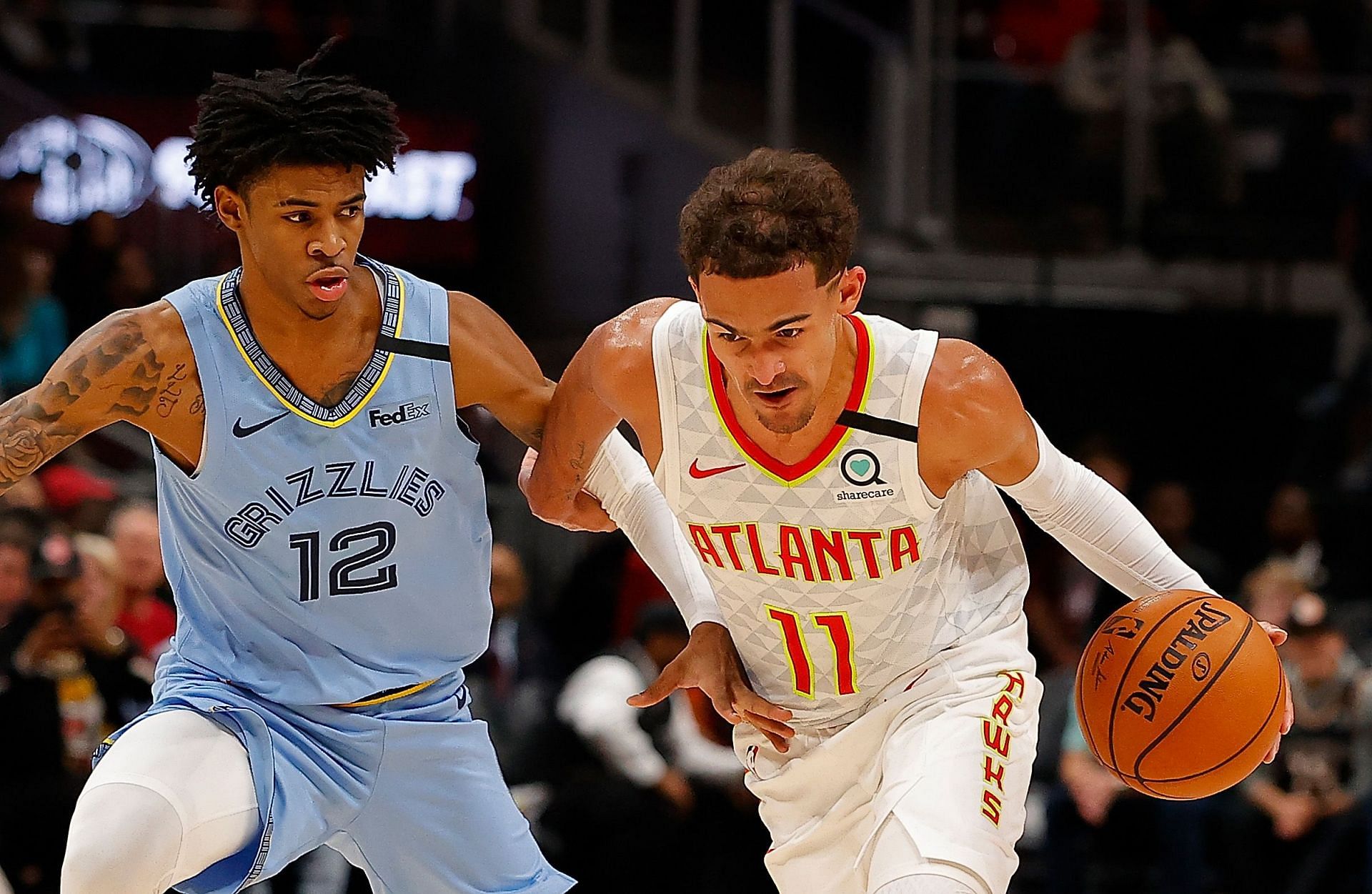 Ja Morant (left) defends Trae Young(right)