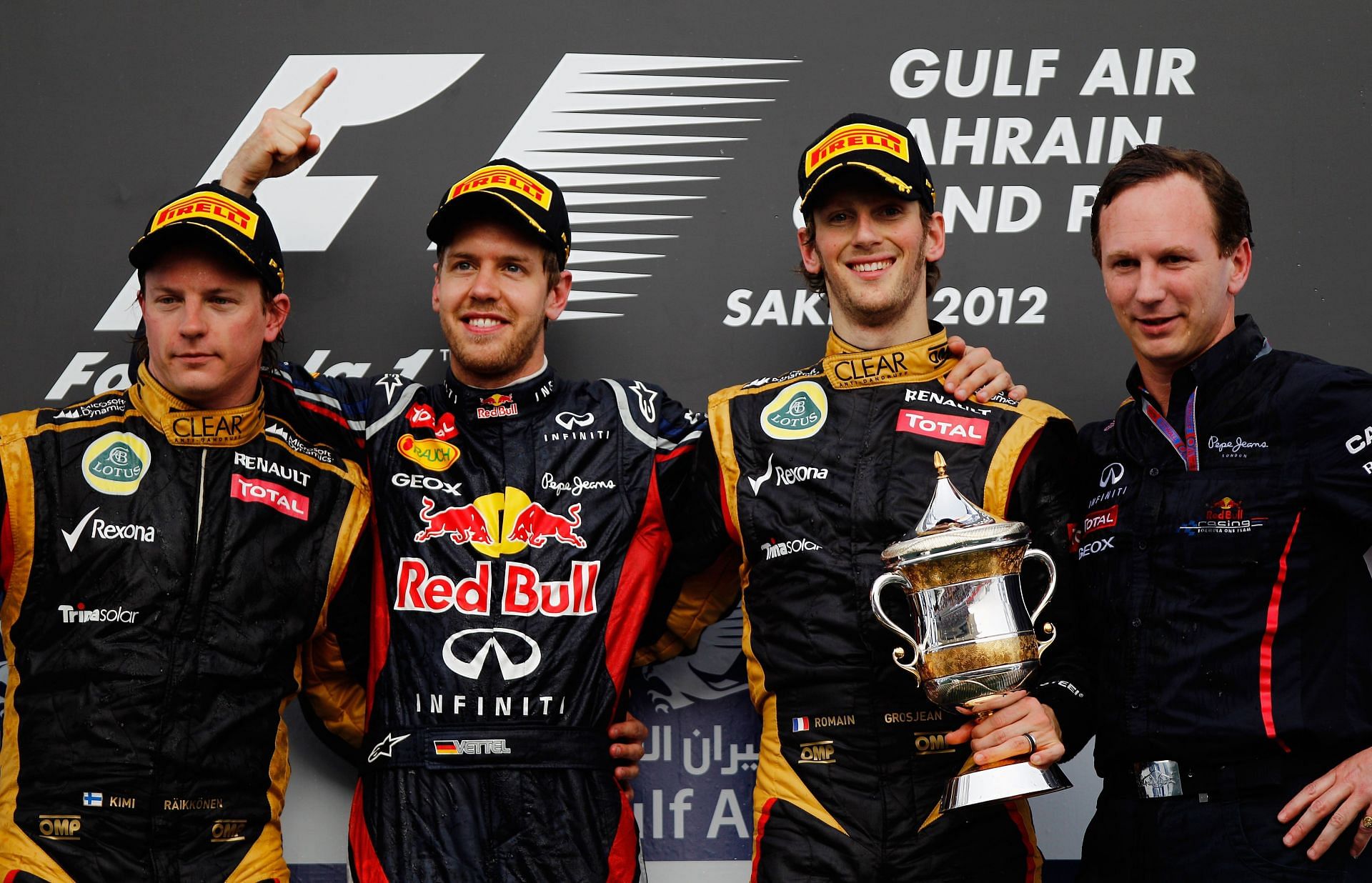 (L-R) Kimi Raikkonen, Sebastian Vettel, Romain Grosjean and Christian Horner share the 2012 Bahrain Grand Prix podium.